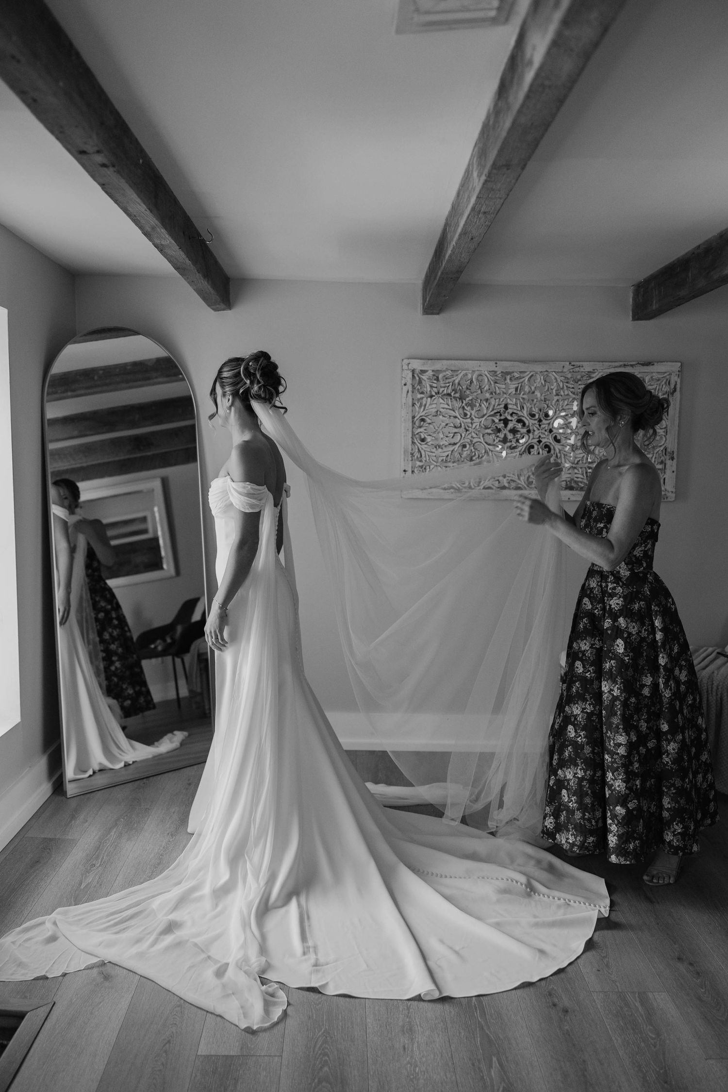 Birmingham Alabama Photographer capturing bride and her mother posing with her wedding dress, at Iris Woods Venue in Nashville, Tennessee