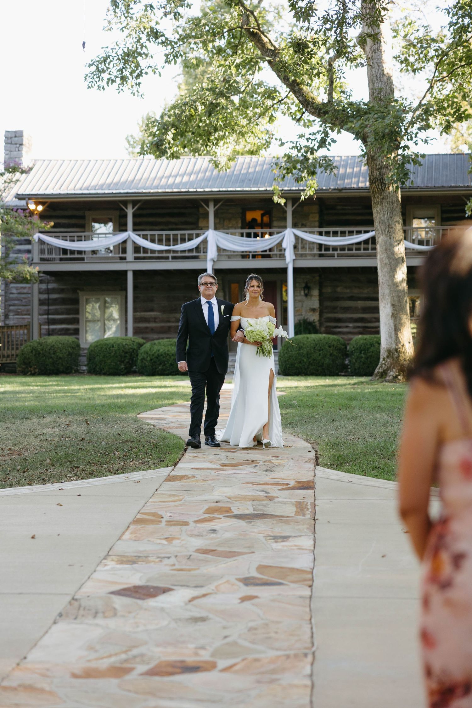Birmingham Alabama Photographer capturing bride walking down the isle to the ceremony space, at Iris Woods Venue in Nashville, Tennessee