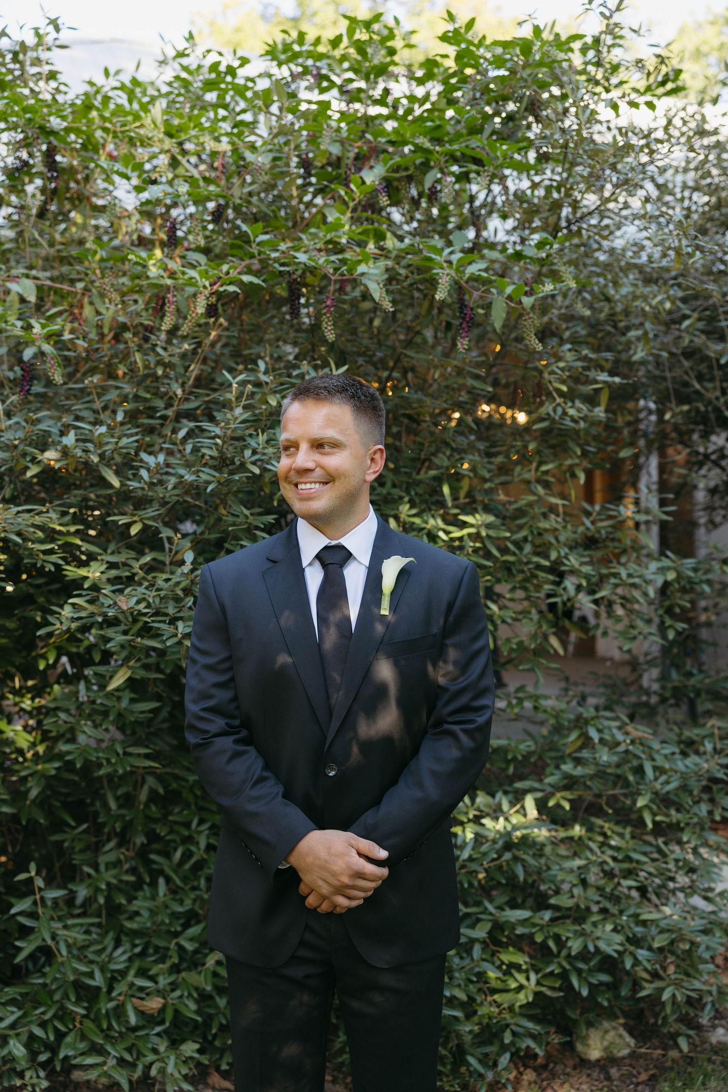 Birmingham Alabama Photographer capturing groom holding his hands and smiling, at Iris Woods Venue in Nashville, Tennessee
