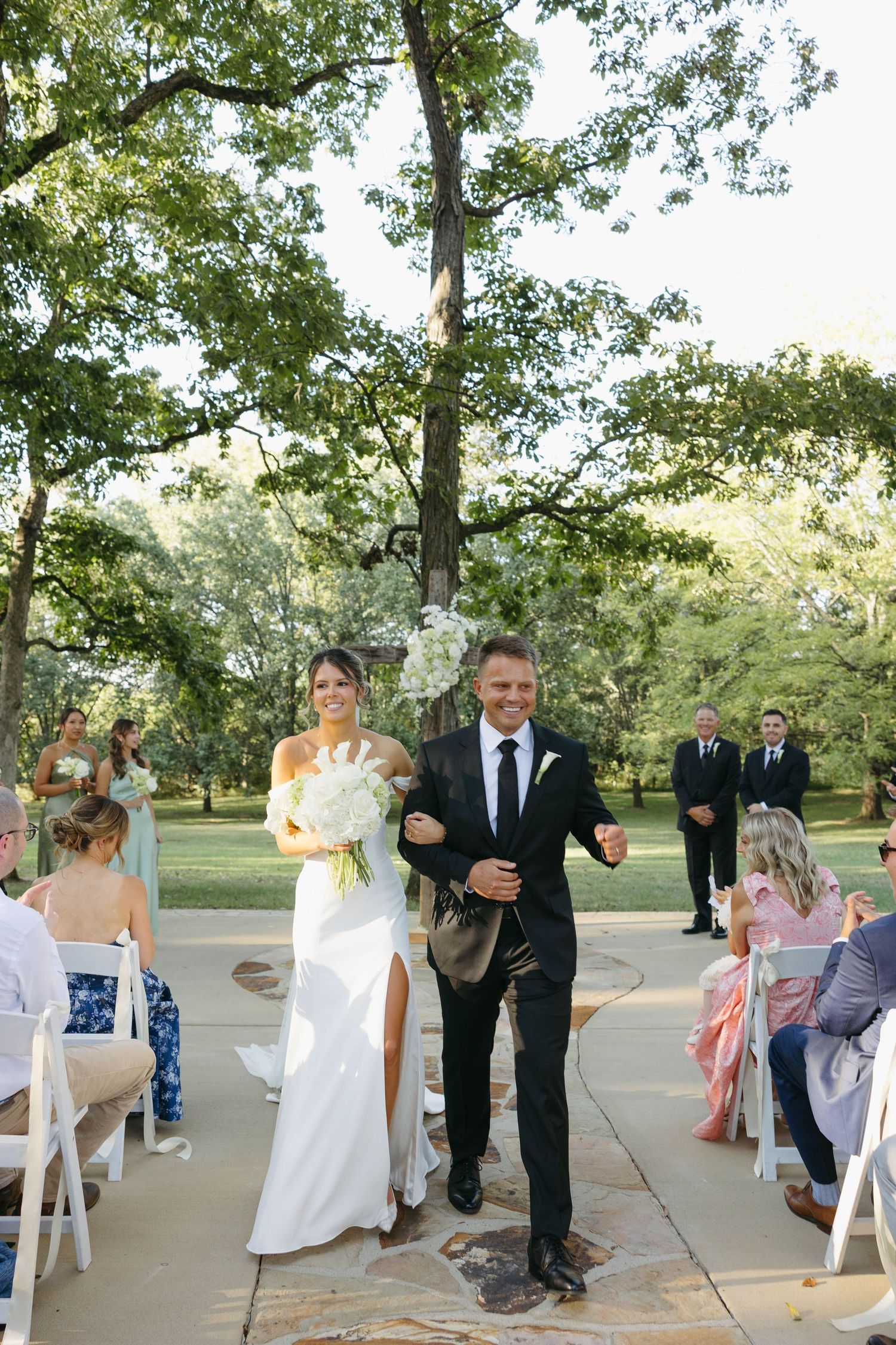 Birmingham Alabama Photographer capturing bride and groom walking out of ceremony space, at Iris Woods Venue in Nashville, Tennessee