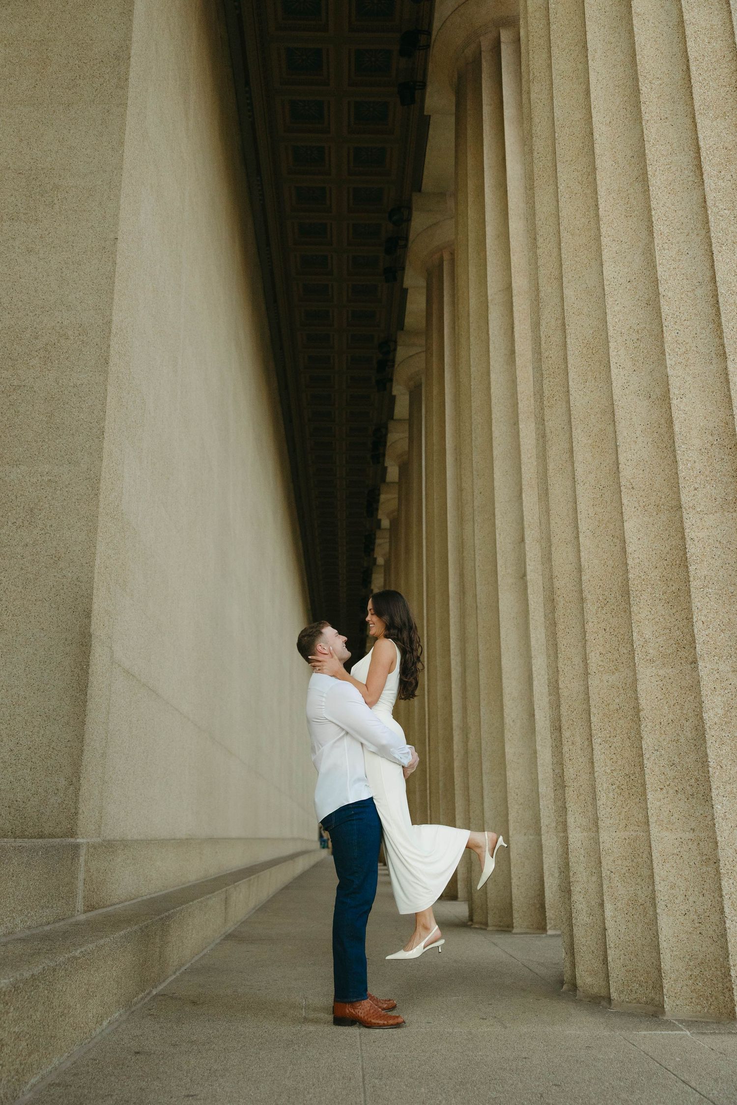 Birmingham Alabama Photographer capturing an engagement session of a couple posing and smiling  in Nashville Tennessee at the Parthenon