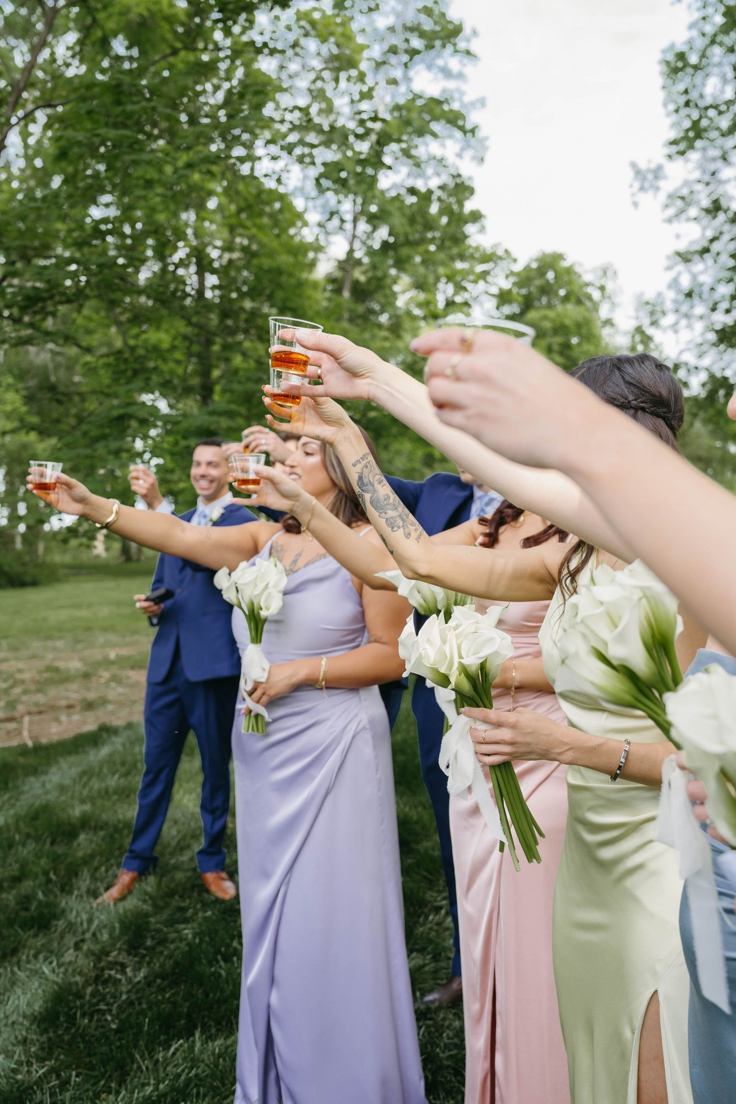 Birmingham Alabama Photographer capturing guests toasting at the digging up of bourbon, at Iris Woods Venue in Nashville, Tennessee