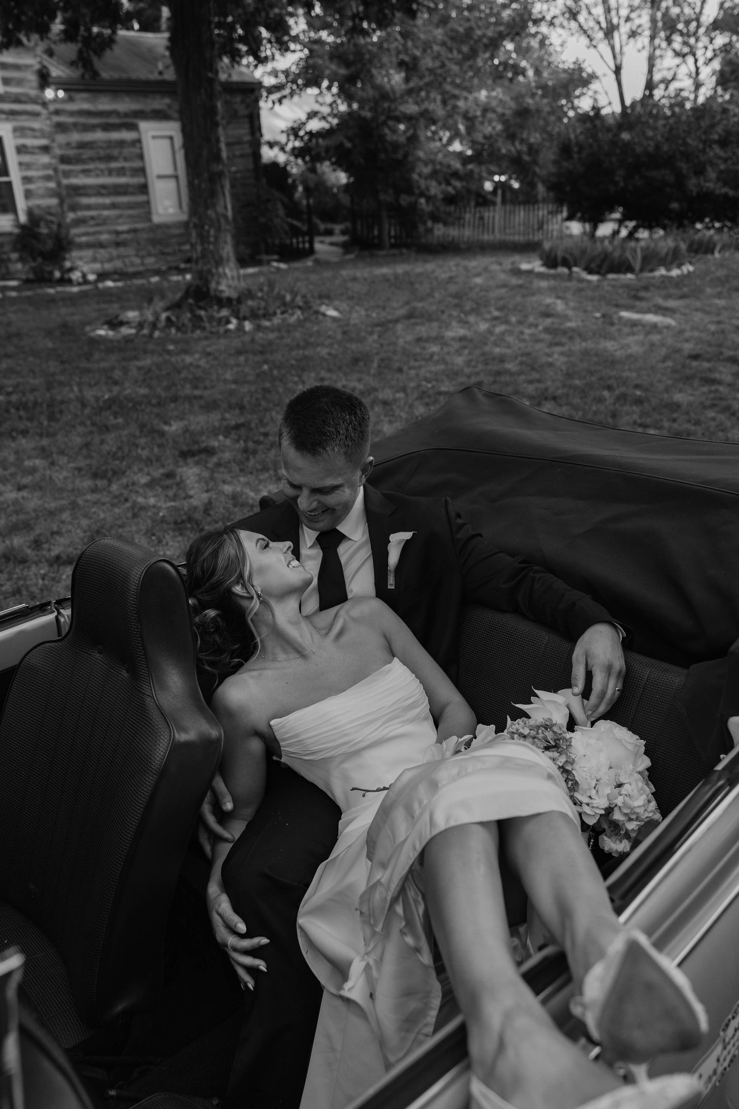 Birmingham Alabama Photographer capturing bride and groom posing in a Volkswagen beetle, at Iris Woods Venue in Nashville, Tennessee