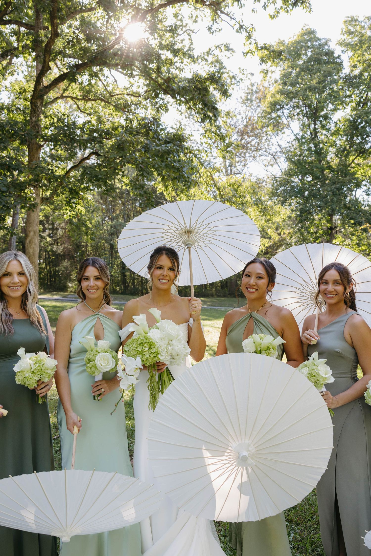 Birmingham Alabama Photographer capturing bride and bridesmaids posing with their parasols at Iris Woods Venue in Nashville, Tennessee