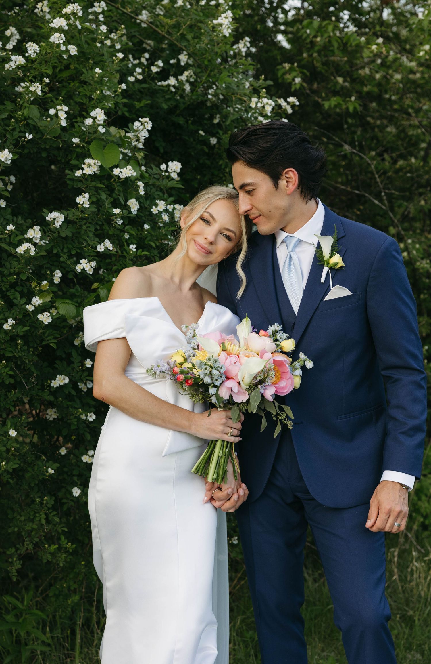 Birmingham Alabama Photographer capturing bride and groom posing, in a field, at Iris Woods Venue in Nashville, Tennessee