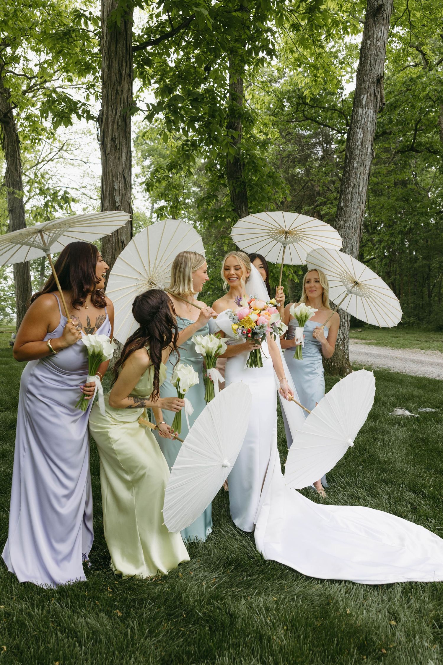 bride with her bridesmaids and their parasols
