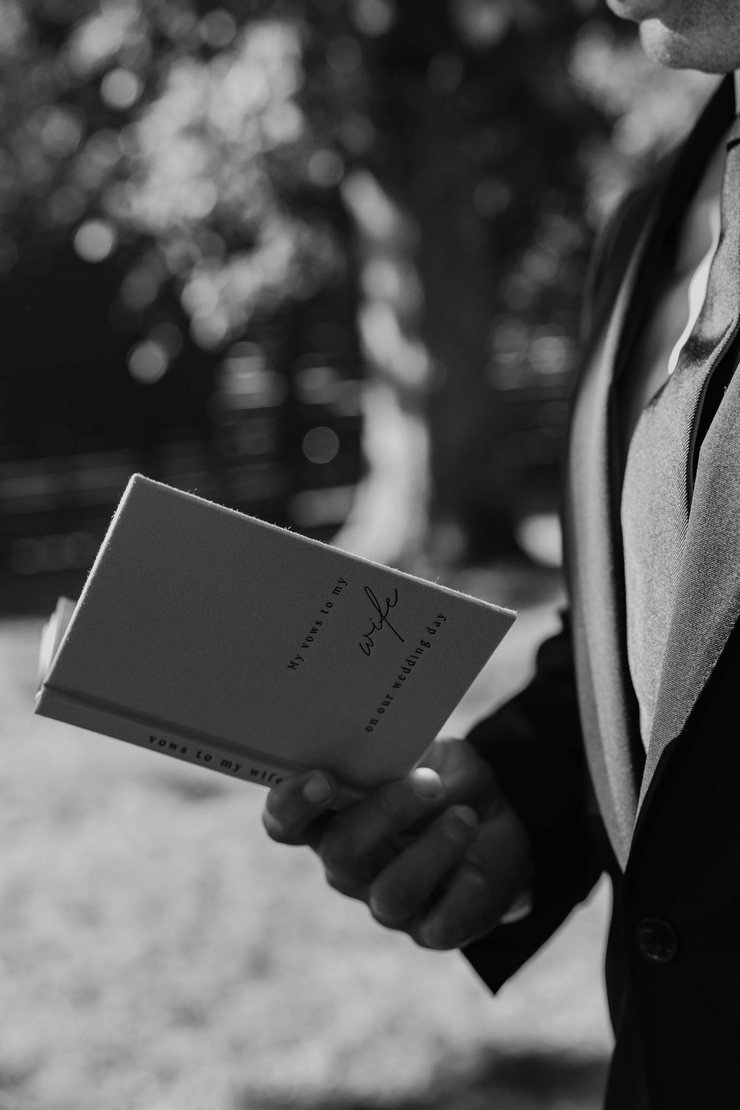 Birmingham Alabama Photographer capturing bride and groom reading their pre wedding vows, at Iris Woods Venue in Nashville, Tennessee