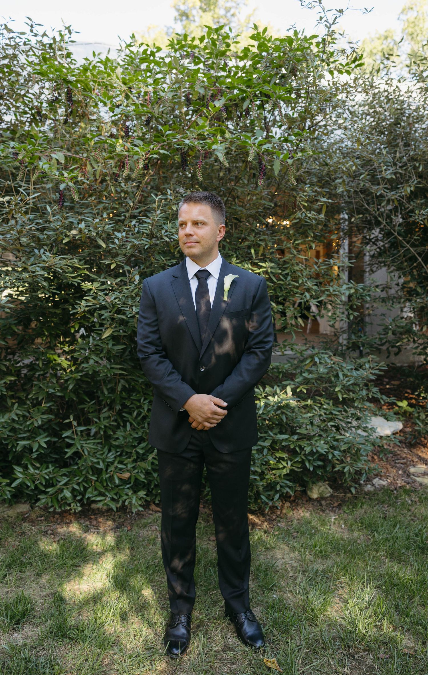 Birmingham Alabama Photographer capturing groom holding his hands and smiling, at Iris Woods Venue in Nashville, Tennessee