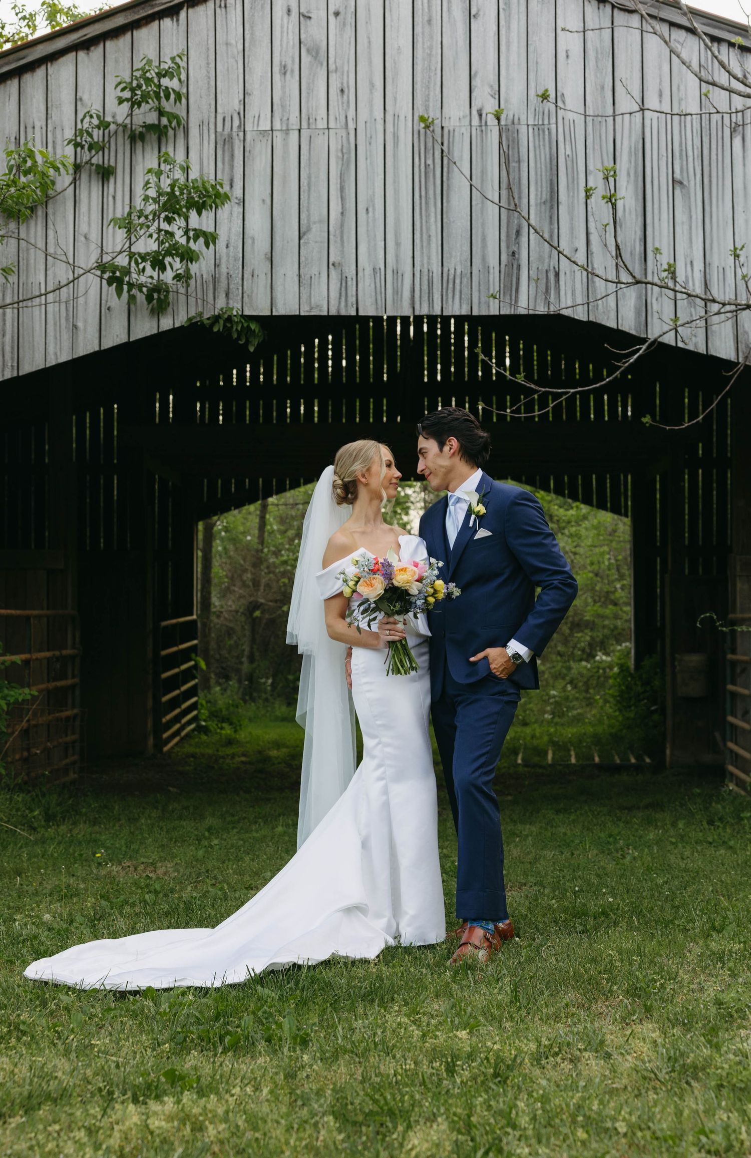 Birmingham Alabama Photographer capturing bride and groom posing in a field, at Iris Woods Venue in Nashville, Tennessee