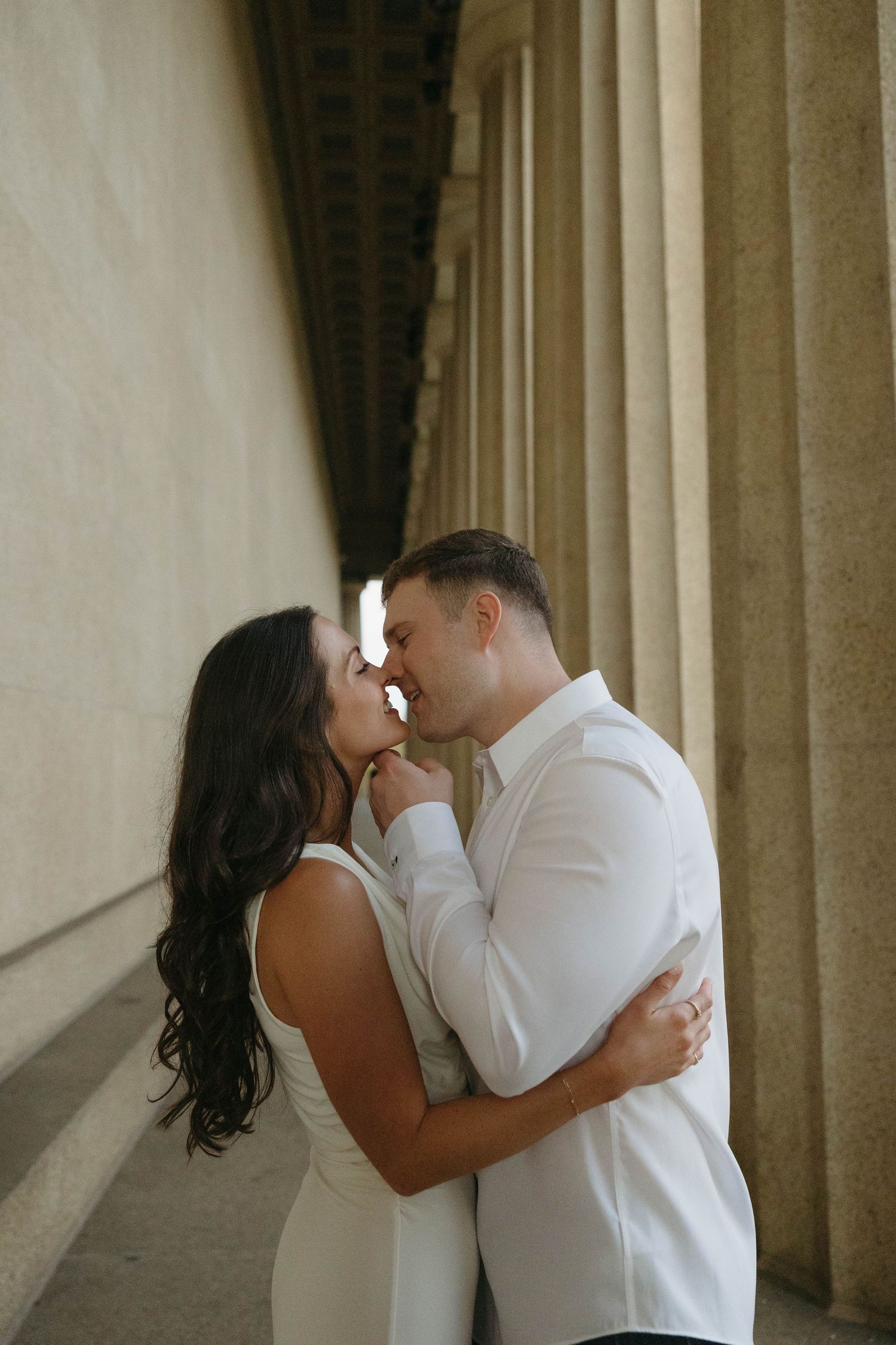 Birmingham Alabama Photographer capturing an engagement session of a couple slowly kissing in Nashville Tennessee at the Parthenon