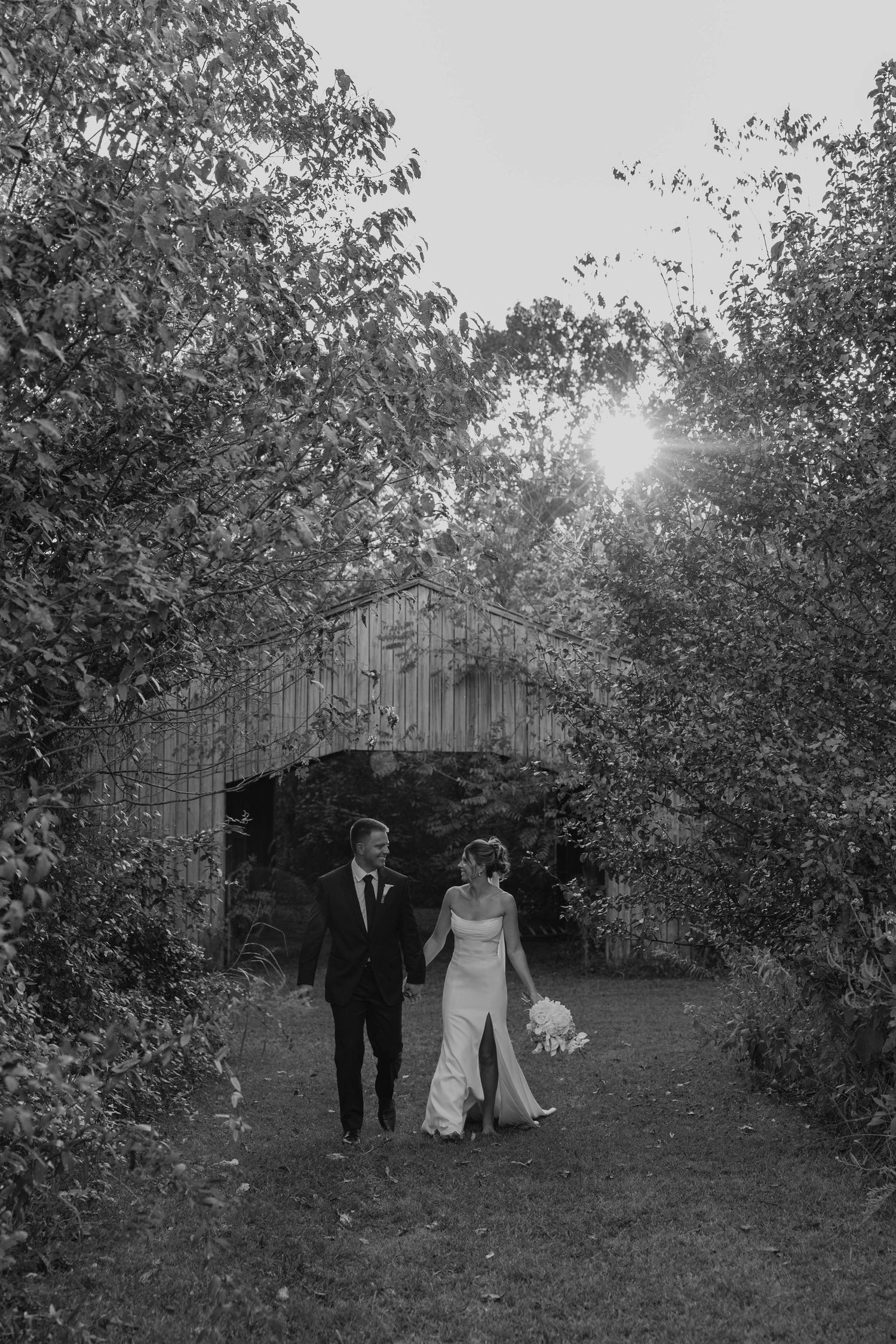 Birmingham Alabama Photographer capturing Bride and groom running in a field, at iris woods wedding venue in Nashville Tennessee