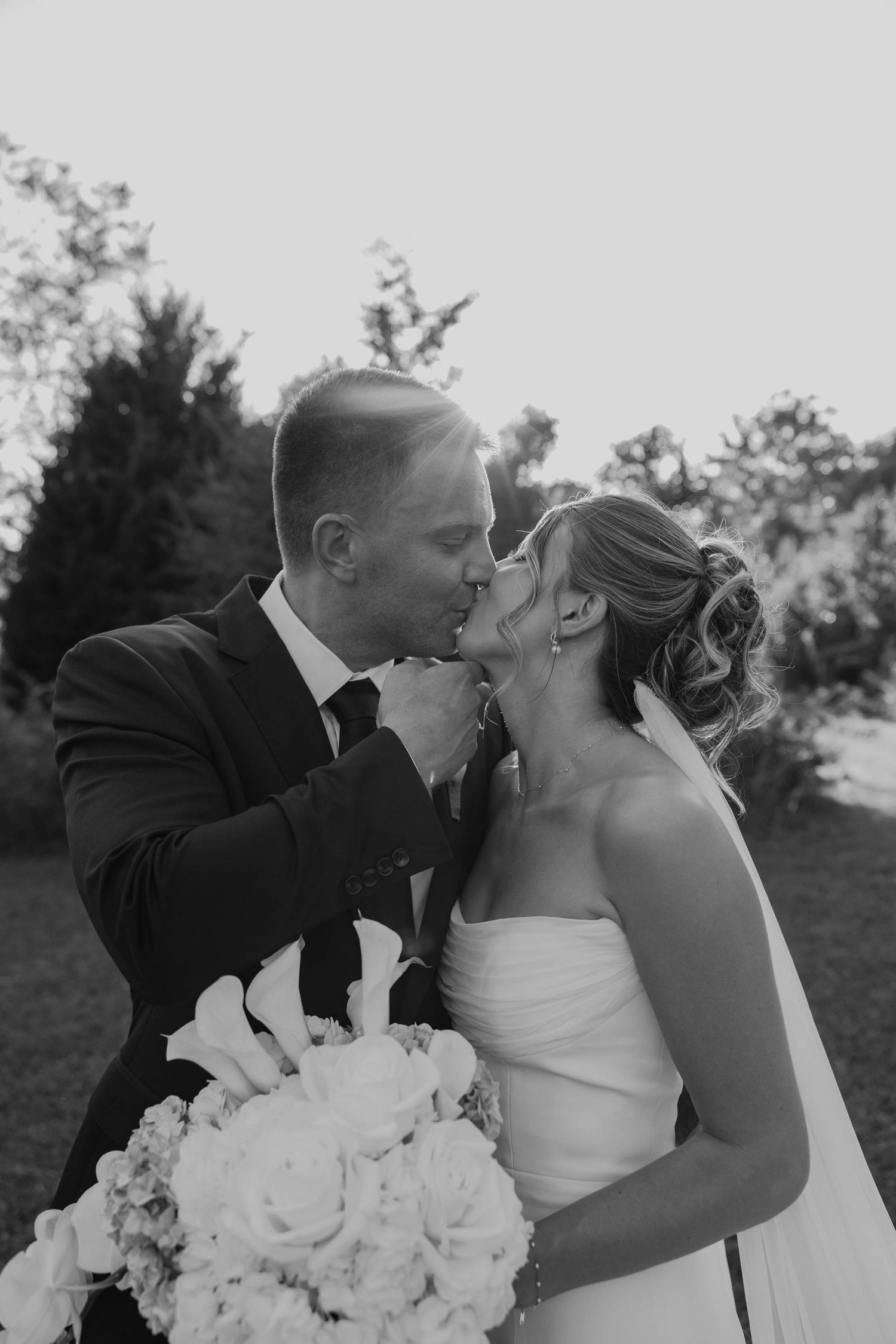 Birmingham Alabama Photographer capturing bride and groom kissing in a field, at Iris Woods Venue in Nashville, Tennessee