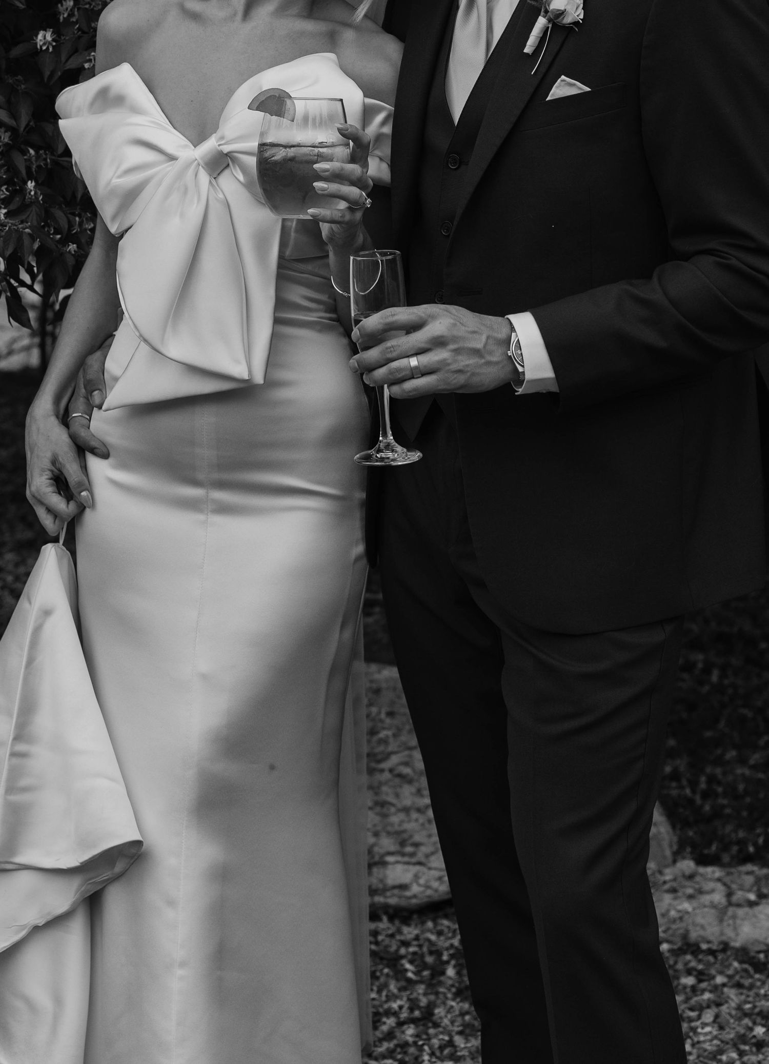 Birmingham Alabama Photographer capturing bride and groom holding wine glasses, in a field, at Iris Woods Venue in Nashville, Tennessee