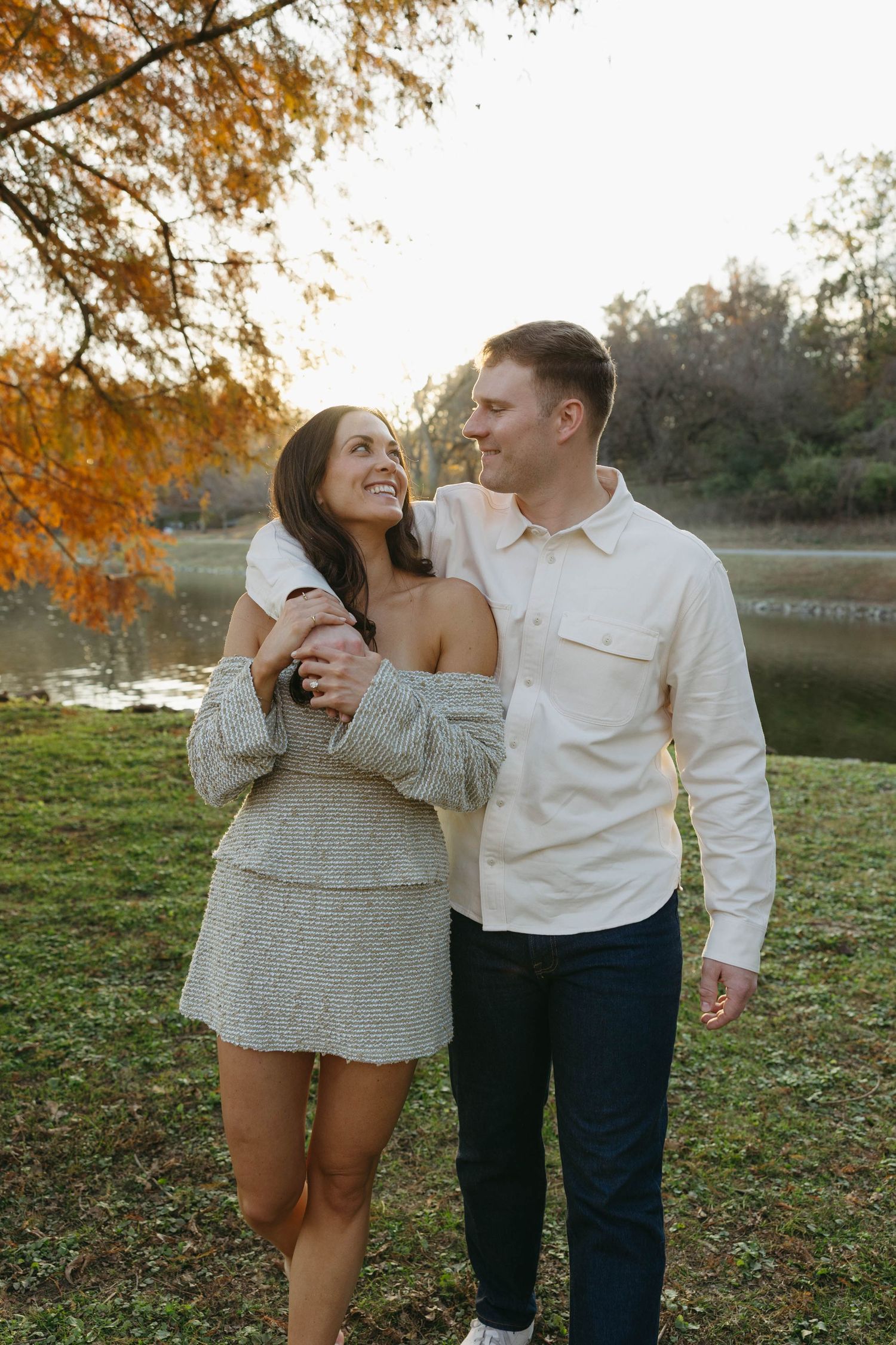 Birmingham Alabama Photographer capturing an engagement session of a couple walking in a park by a lake in Nashville Tennessee