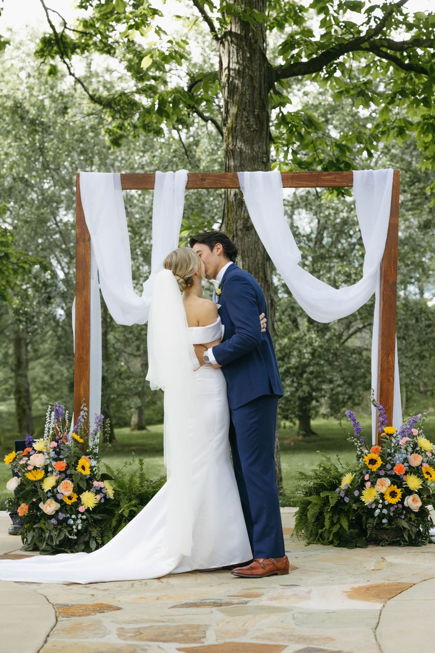 Birmingham Alabama Photographer capturing bride and groom kissing at the ceremony space, at Iris Woods Venue in Nashville, Tennessee