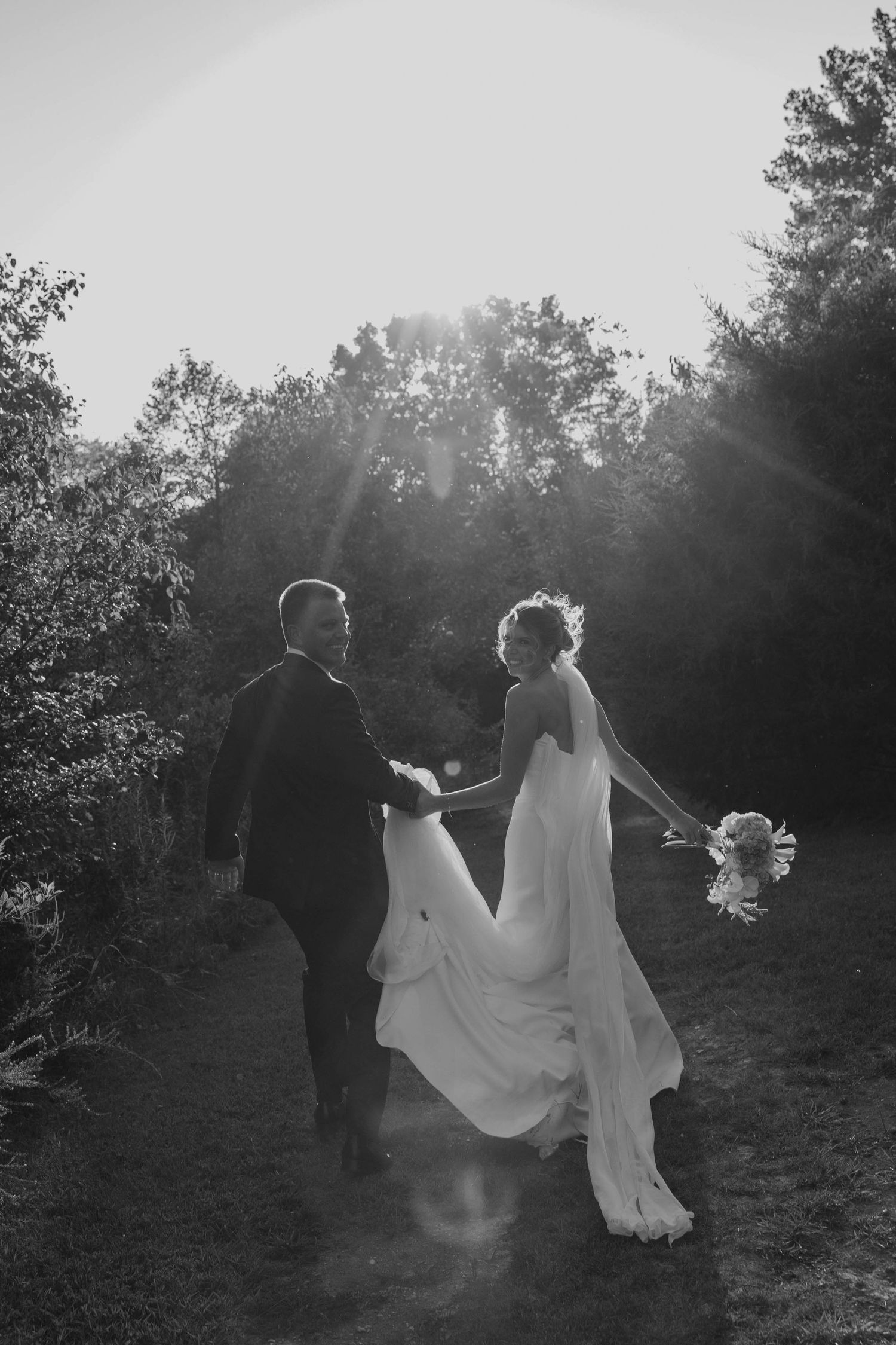 Birmingham Alabama Photographer capturing bride and groom running in a field, at Iris Woods Venue in Nashville, Tennessee