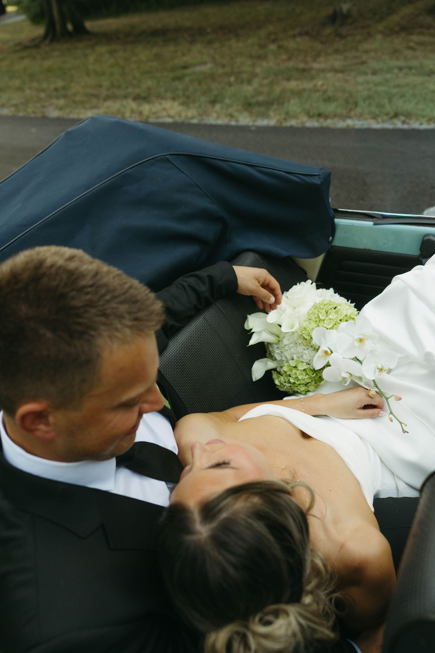 Birmingham Alabama Photographer capturing bride and groom posing in a Volkswagen beetle, at Iris Woods Venue in Nashville, Tennessee
