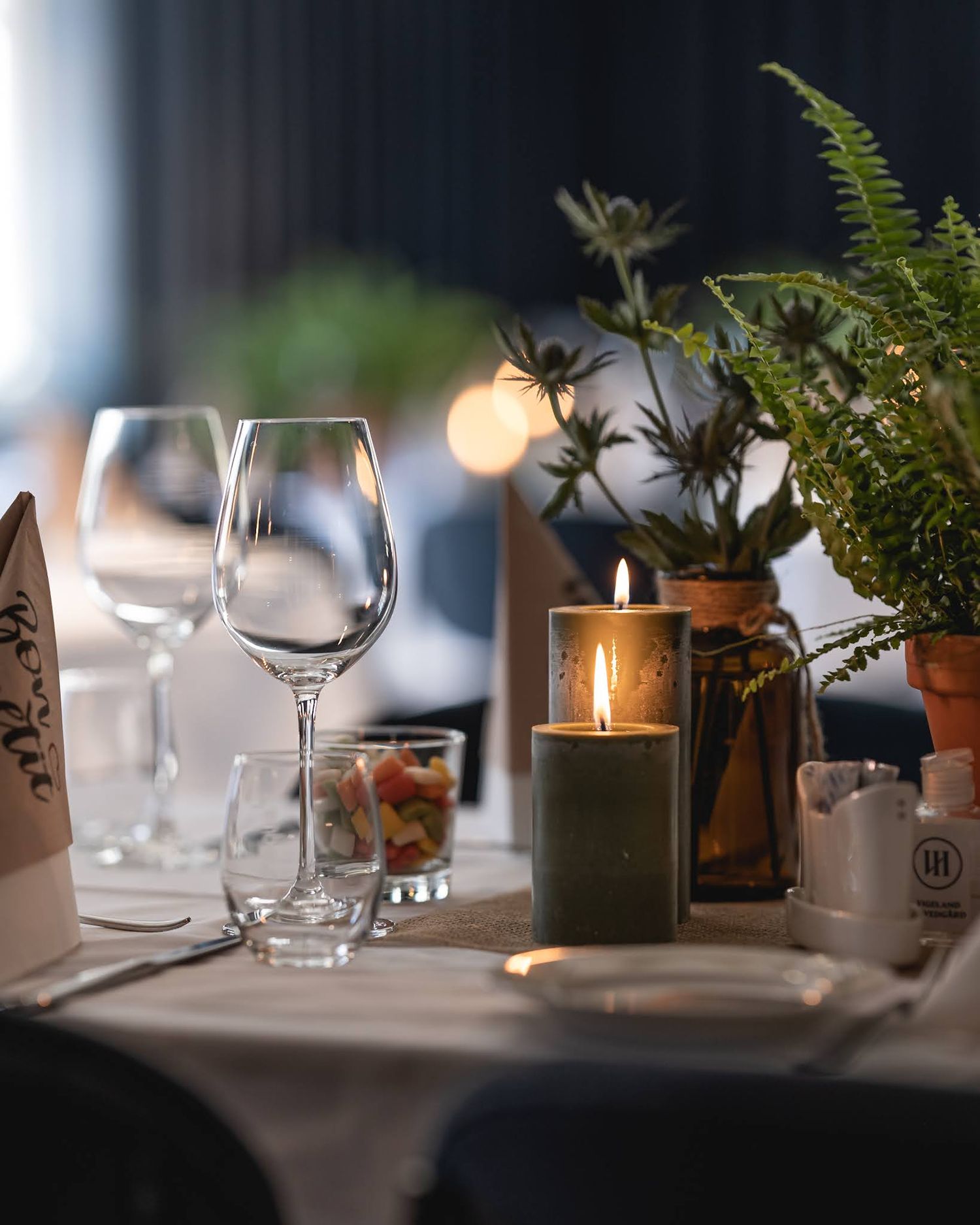Restaurantbord med stearinlys – vinglass og stemningsfull belysning