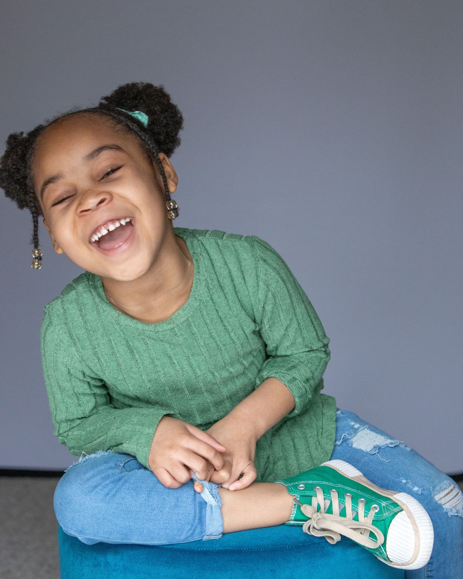 studio child photography in Rochester, MI by Jocelyn M. Photography—close-up of 5-year-old girl with puff buns hair.