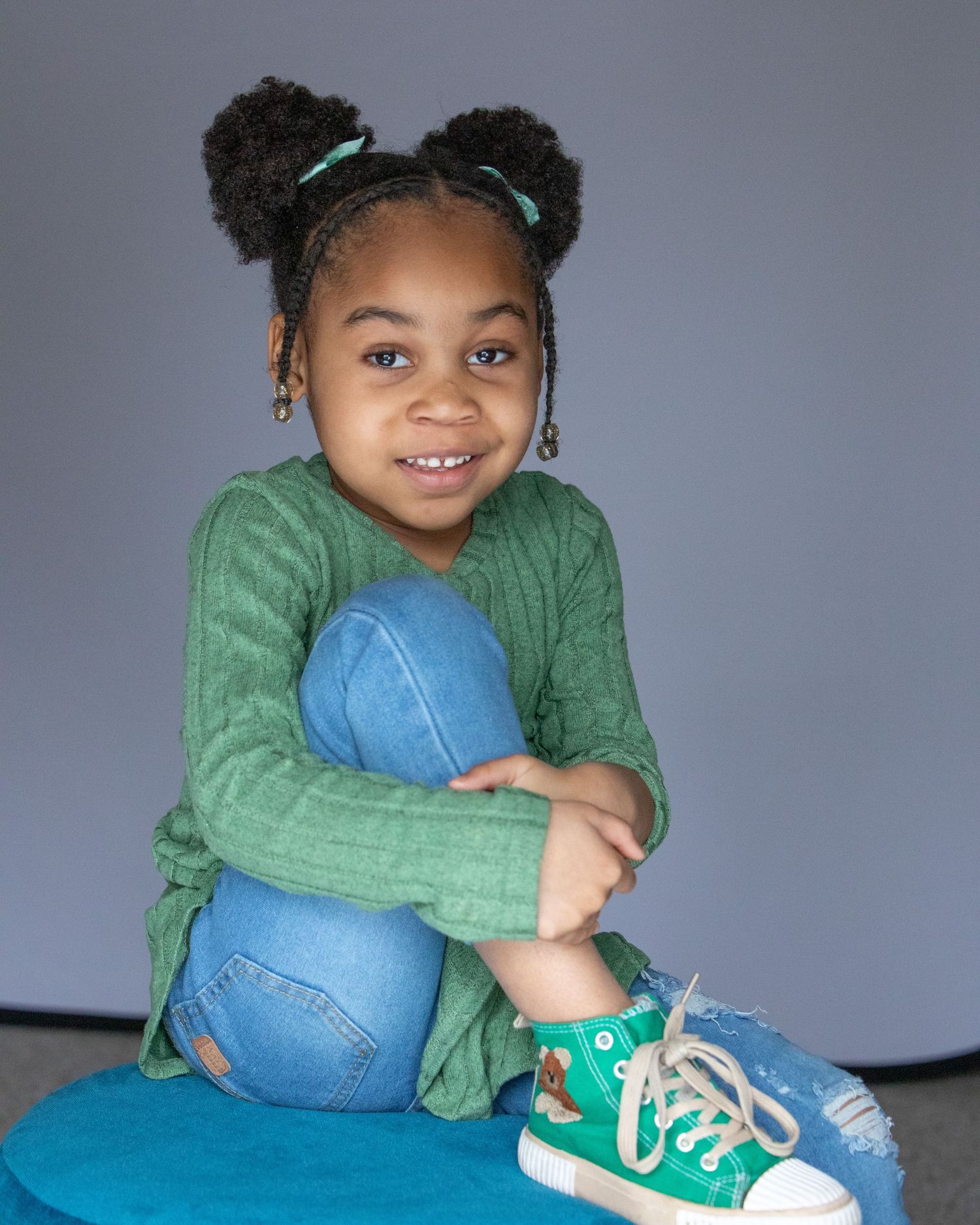 5-year-old child milestone session in Rochester, MI by Jocelyn M. Photography—young girl with puff buns on a stool.