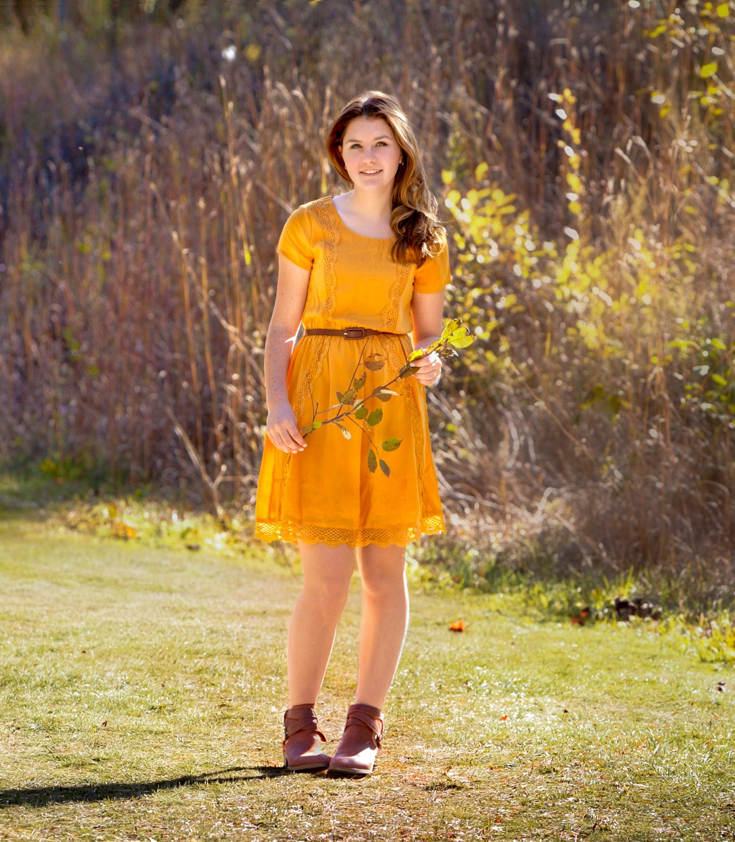 Senior girl portrait standing in a sunny autumn field. by Jocelyn M. Photography in Rochester, MI