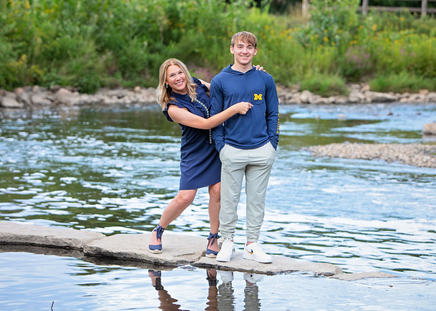 High school senior portrait in Rochester, MI by Jocelyn M. Photography—mother and son on river stepping stones.