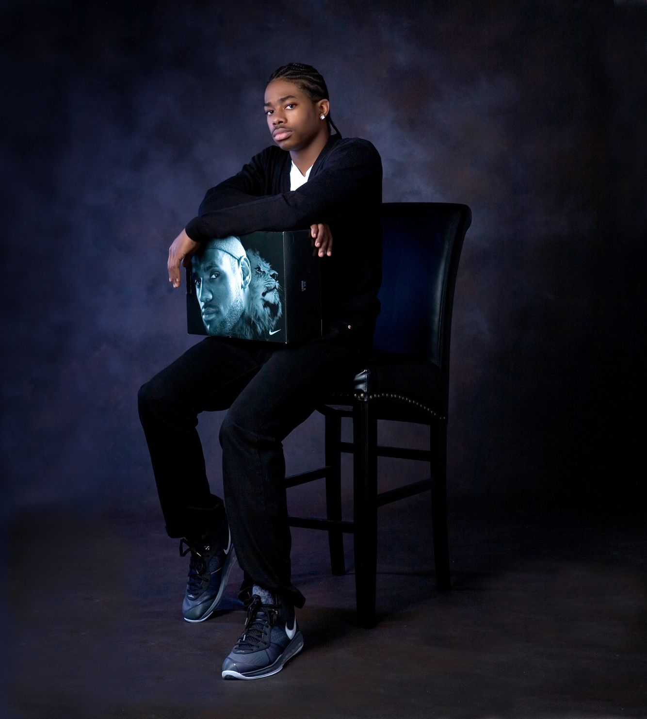 Creative senior portrait for guys in Rochester, MI by Jocelyn M. Photography—teen boy in all black posing in studio.