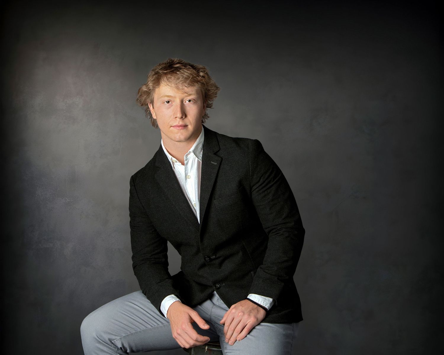 Professional guy's portrait in Rochester, MI by Jocelyn M. Photography—young man in a black blazer and white shirt.