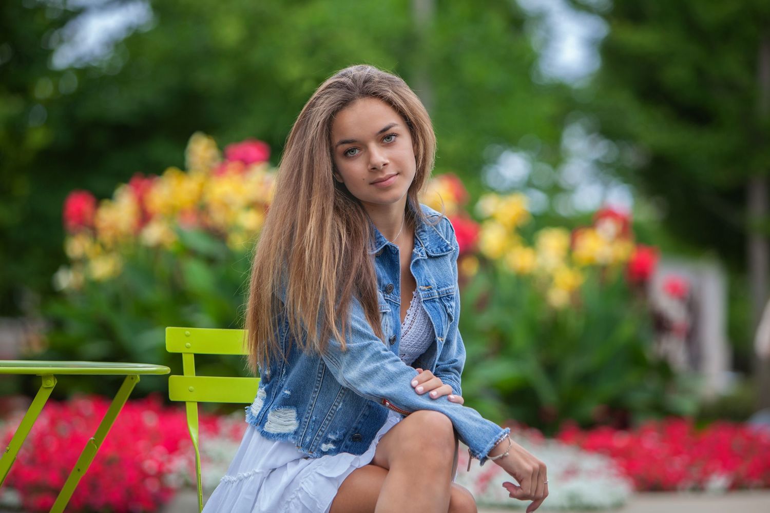 16-year child milestone portrait in Rochester, MI by Jocelyn M. Photography—teen girl in denim jacket on a park bench.