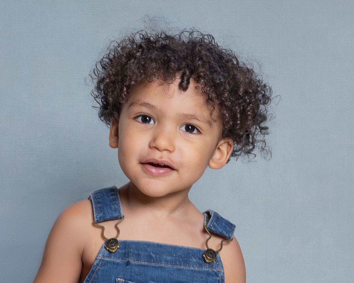 Child portrait studio in Rochester, MI by Jocelyn M. Photography—close-up of a smiling 2-year-old toddler boy.
