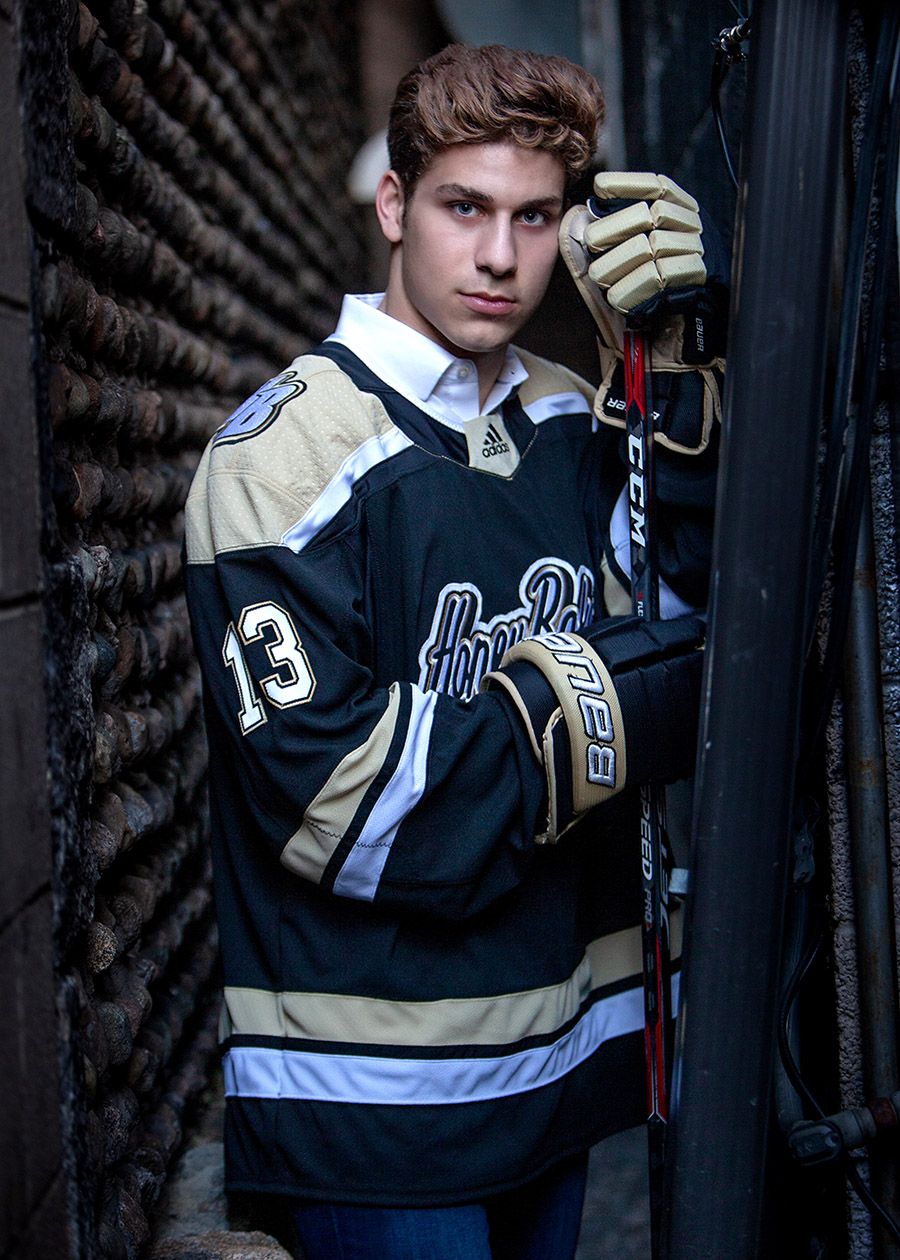 Hockey senior portrait in Rochester, MI by Jocelyn M. Photography—young athlete in jersey holding a CCM stick.