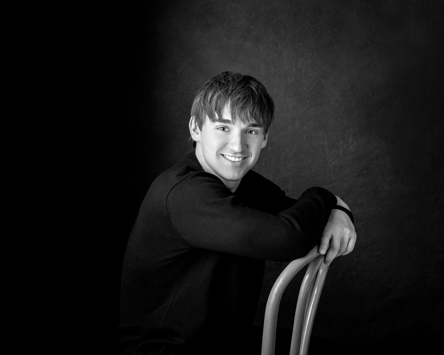 Studio senior Black and white portrait of a young smiling man in Rochester, MI by Jocelyn M. Artistic Photography