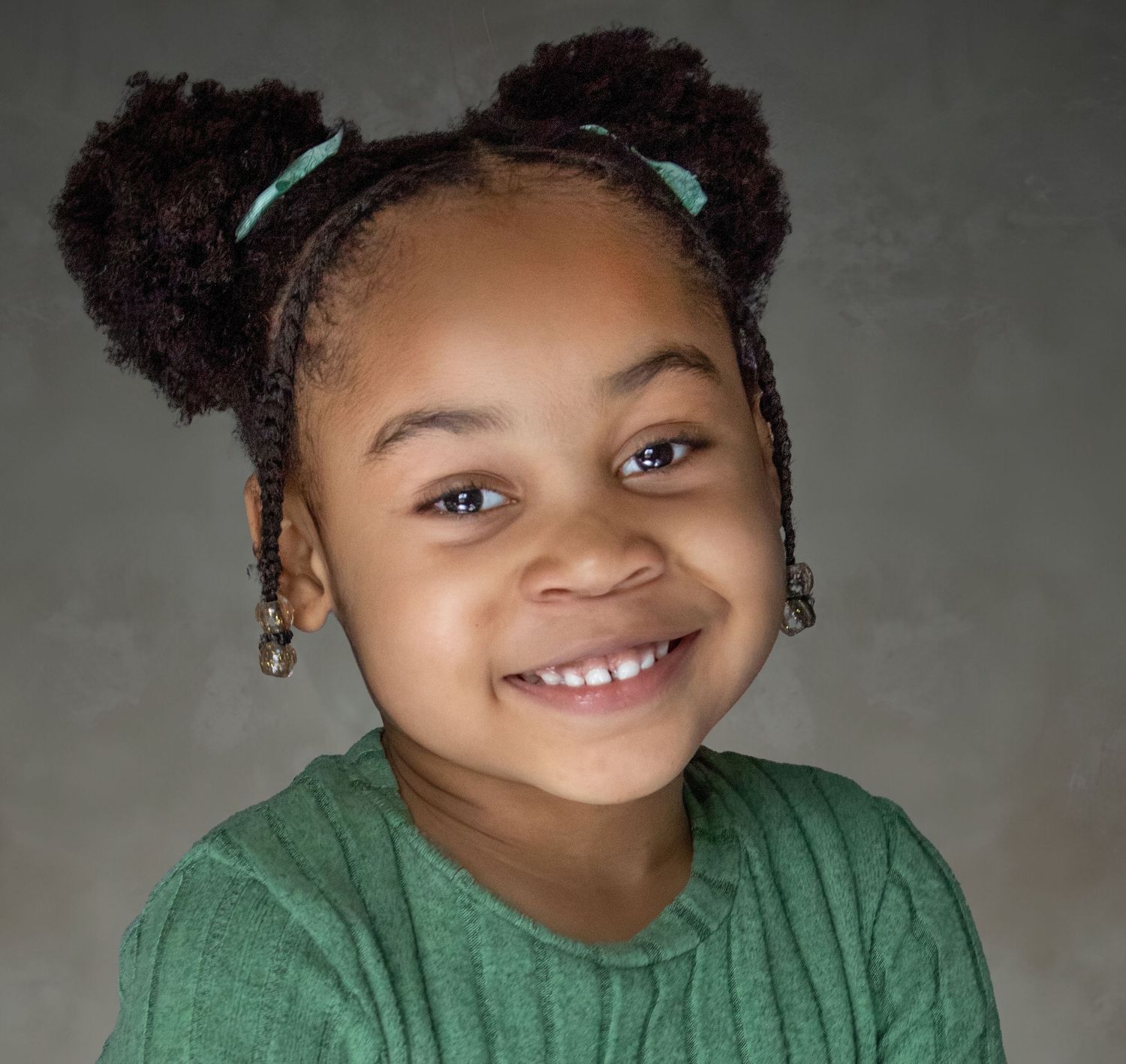 5-year-old child milestone session in Rochester, MI by Jocelyn M. Photography—close-up of young girl with puff buns.