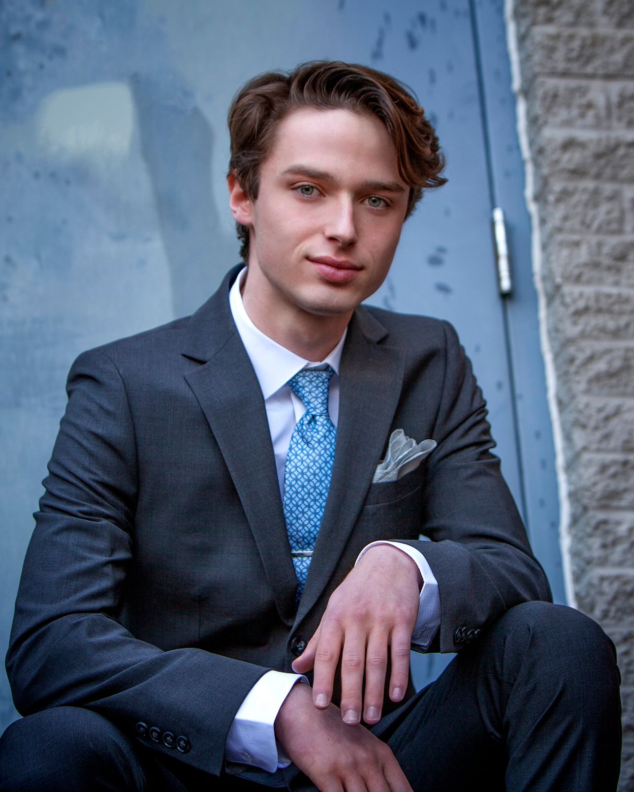 Signature senior portraits for guys in Rochester, MI by Jocelyn M. Photography—young man in a sharp charcoal suit.