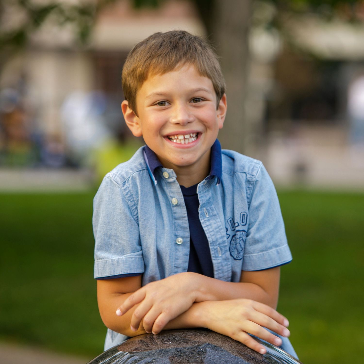 7-year-old child milestone session in Rochester, MI by Jocelyn M. Photography—smiling young boy posing outdoors.
