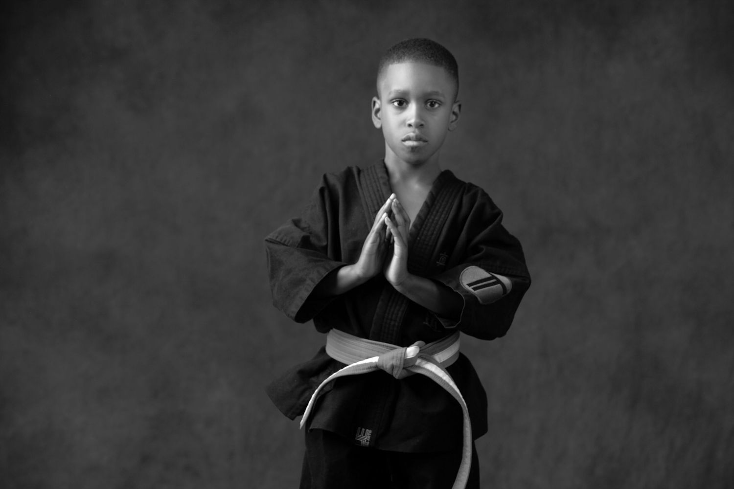Martial arts children's portrait in Rochester, MI by Jocelyn M. Photography—black and white photo of a boy