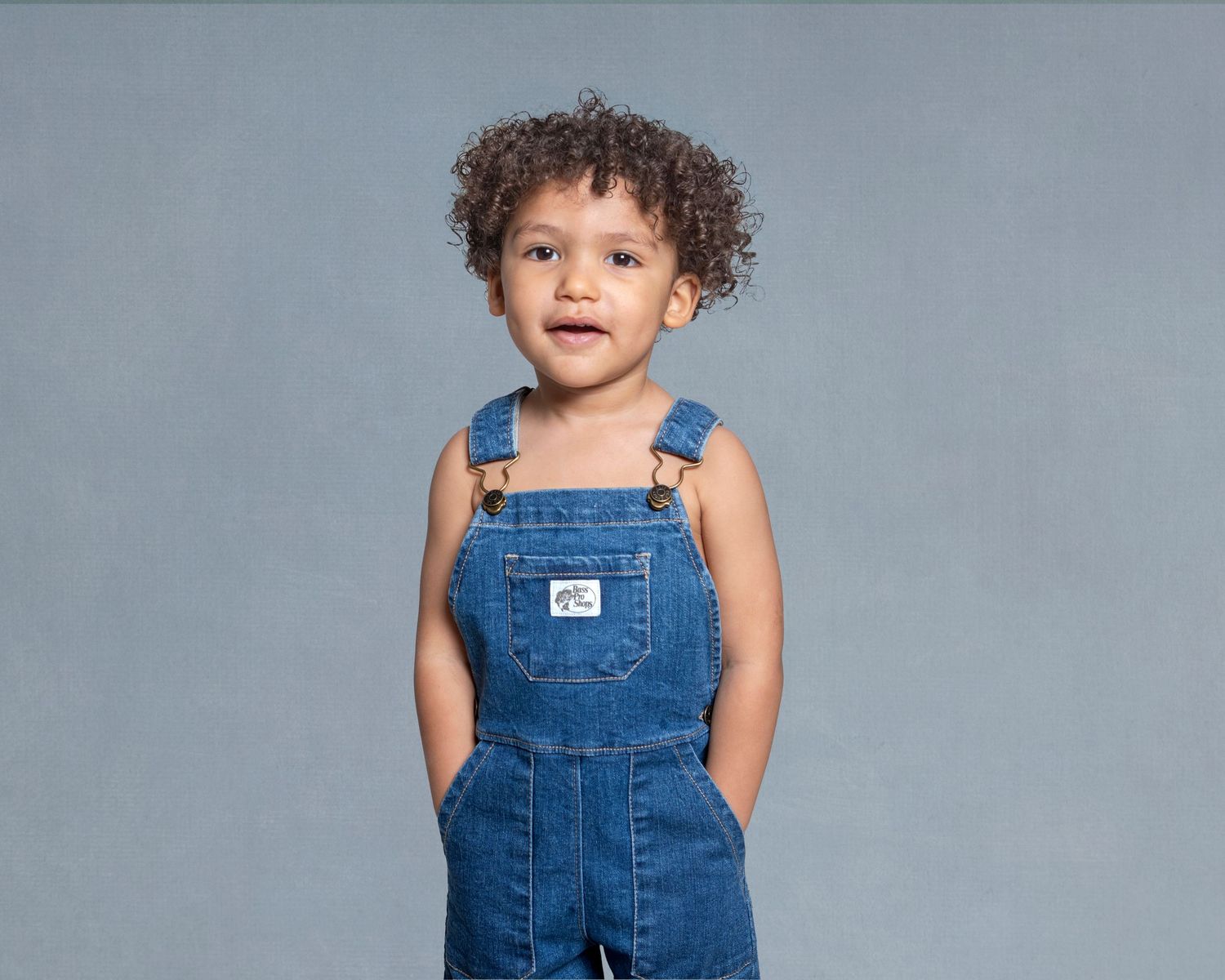 Toddler milestone portrait in Rochester, MI by Jocelyn M. Photography—2-year-old boy in classic blue denim overalls.