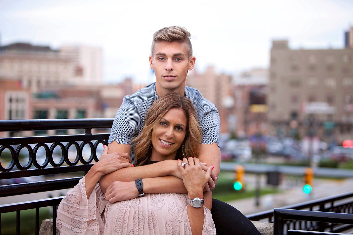 Urban senior portraits in Rochester, MI by Jocelyn M. Photography—mother and high school senior son posing on a bench. (