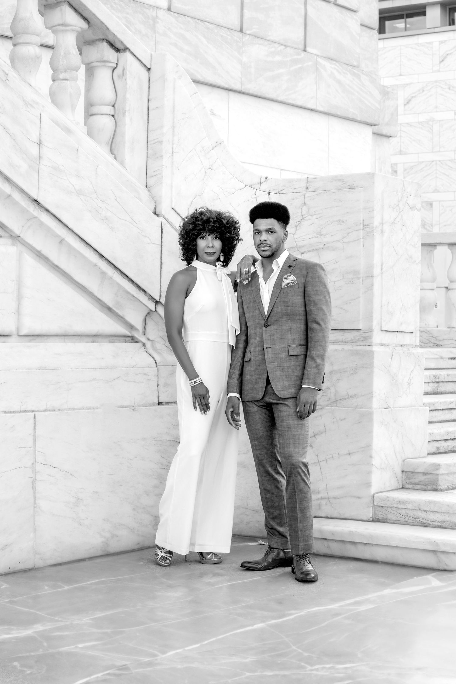 Senior milestone photography by Jocelyn M. Photography—black and white portrait of a mother and son on marble steps.