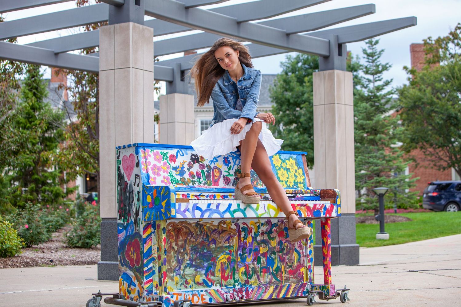 Creative sweet sixteen portrait in Rochester, MI by Jocelyn M. Photography—teen girl posing outdoors on a painted piano.