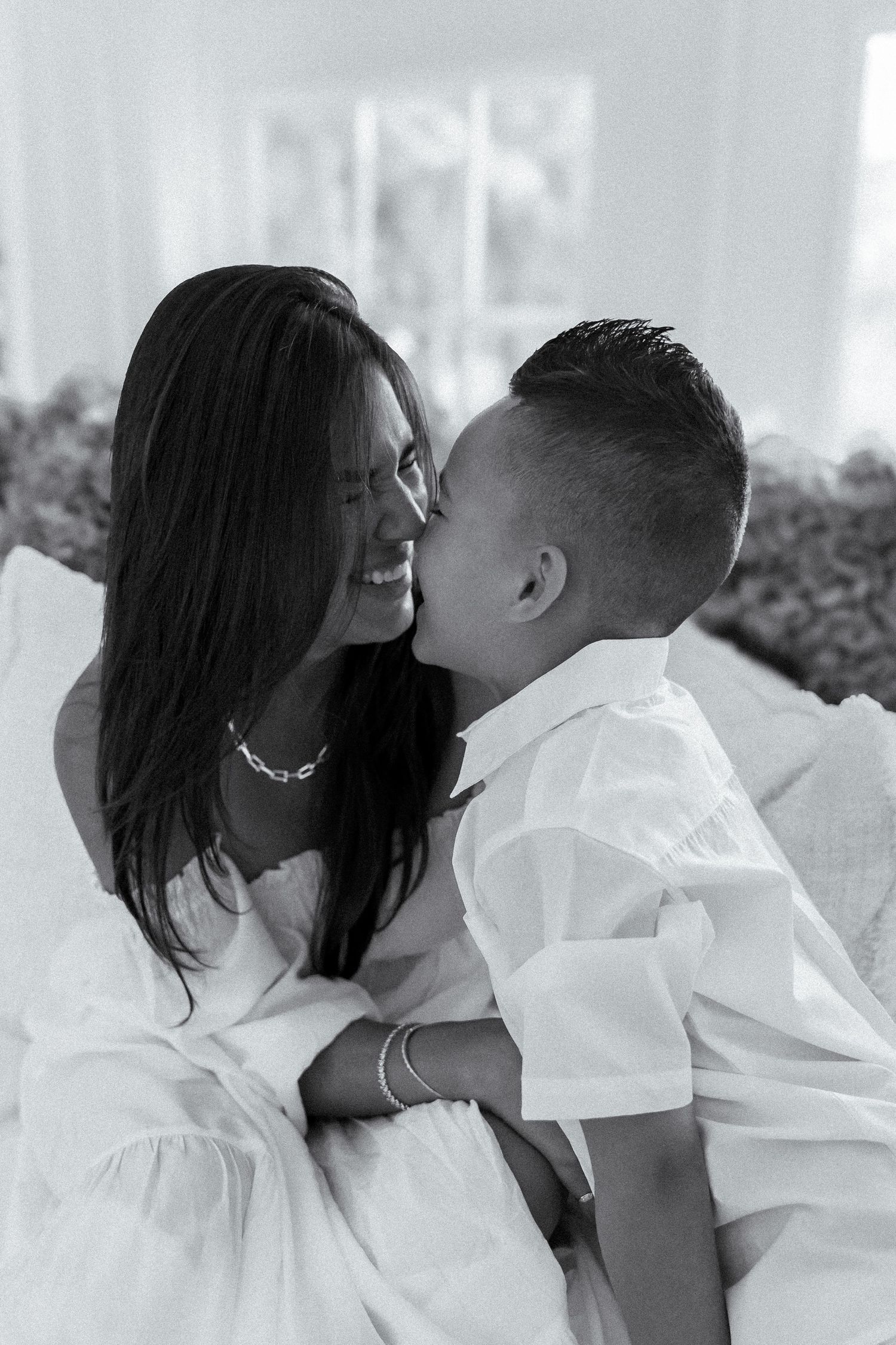 Mother holding child close during in-home lifestyle family session in Coral Gables
