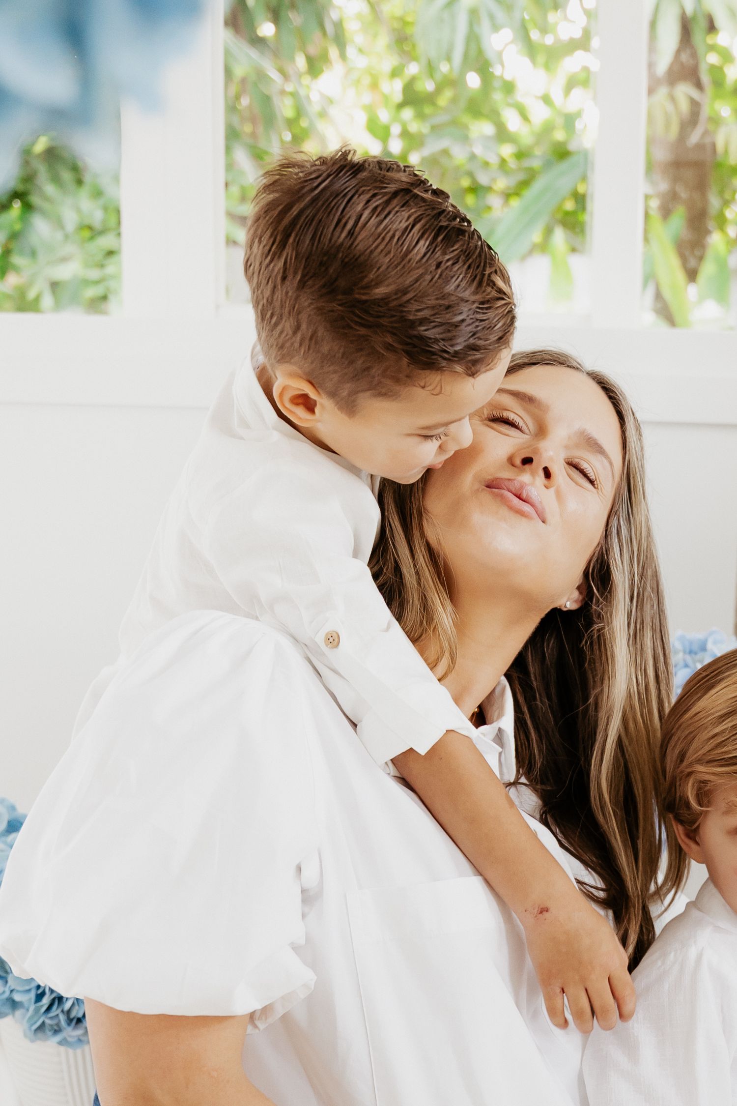 Family sitting together on living room sofa in cozy lifestyle session