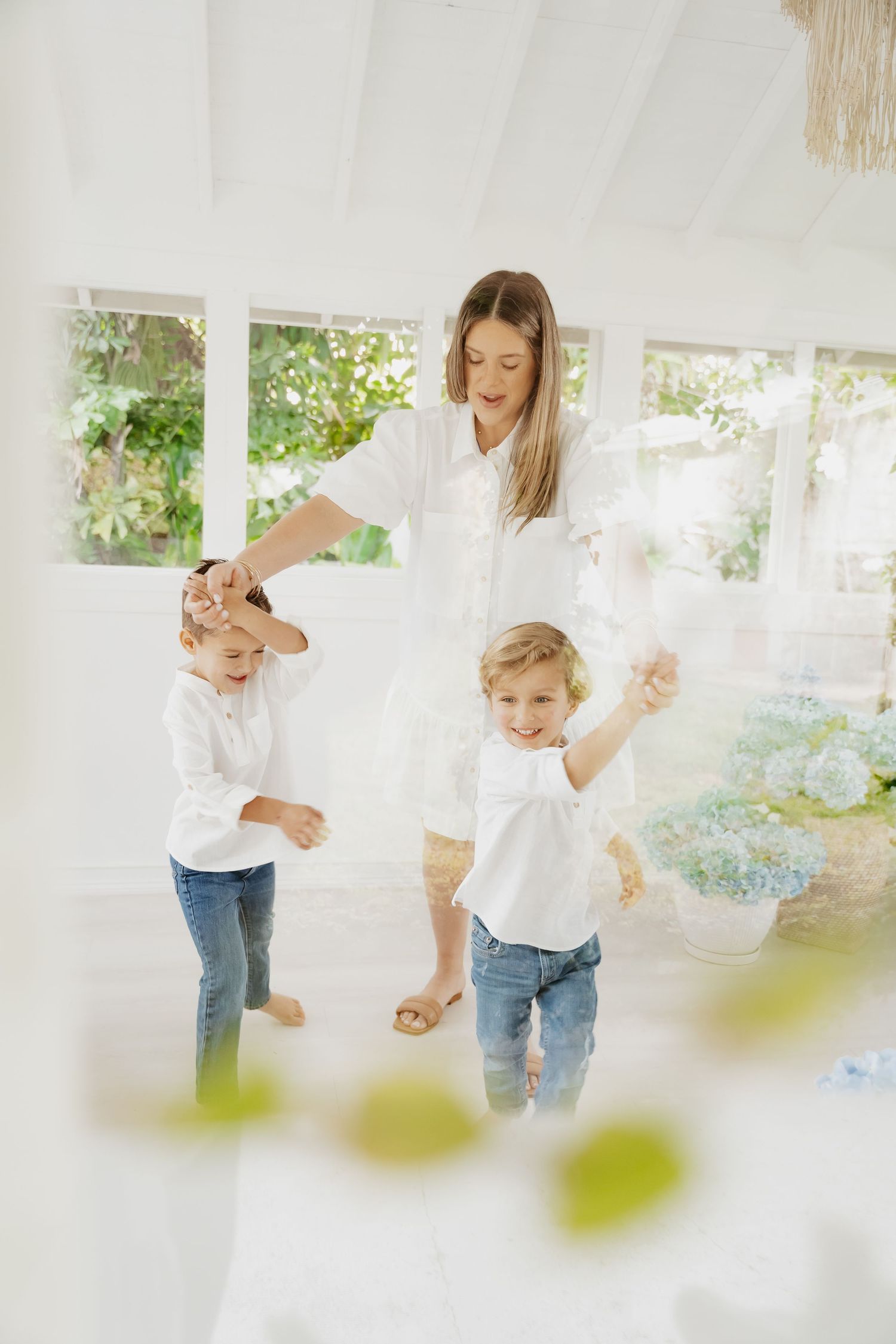 Parents lifting children into the air during playful sunset session