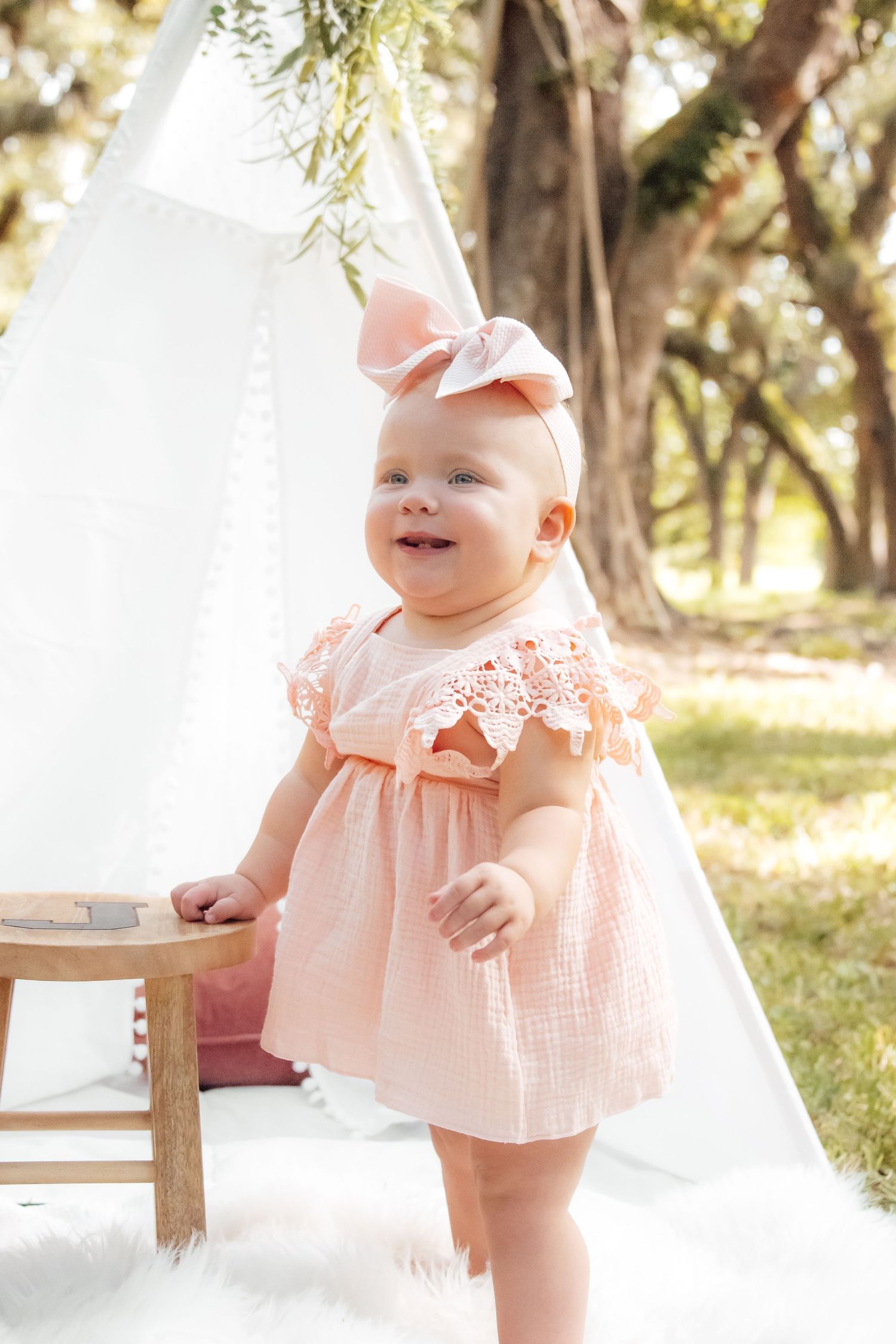 First birthday cake smash with soft pastel decor and joyful expressions