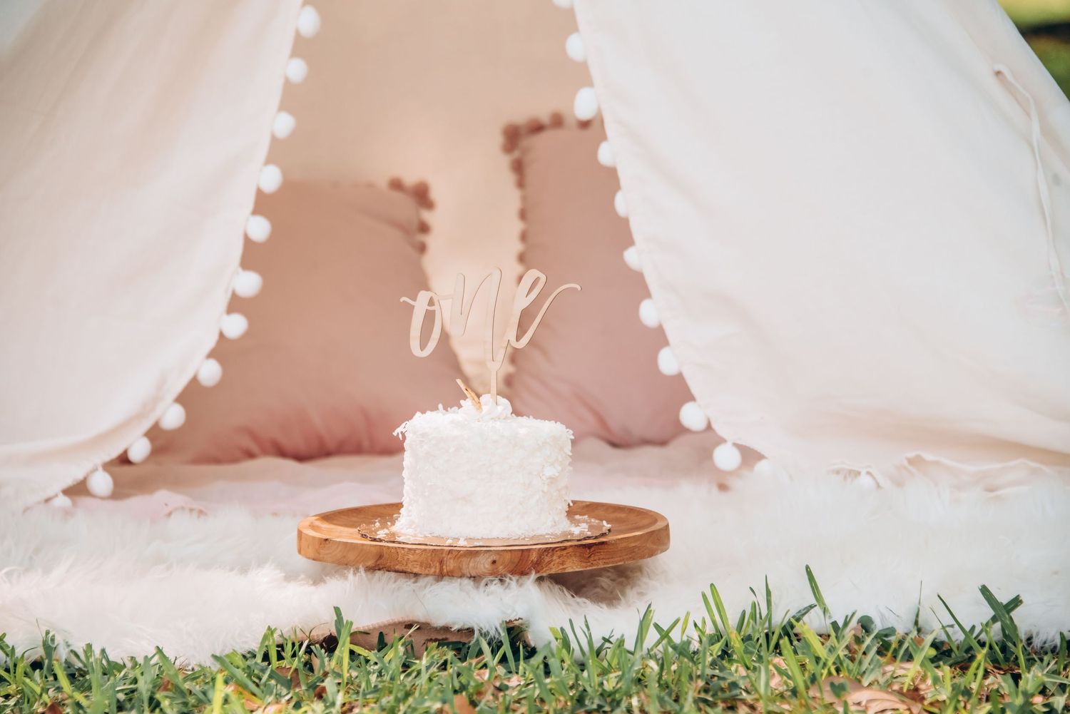 First birthday cake smash with soft pastel decor and joyful expressions