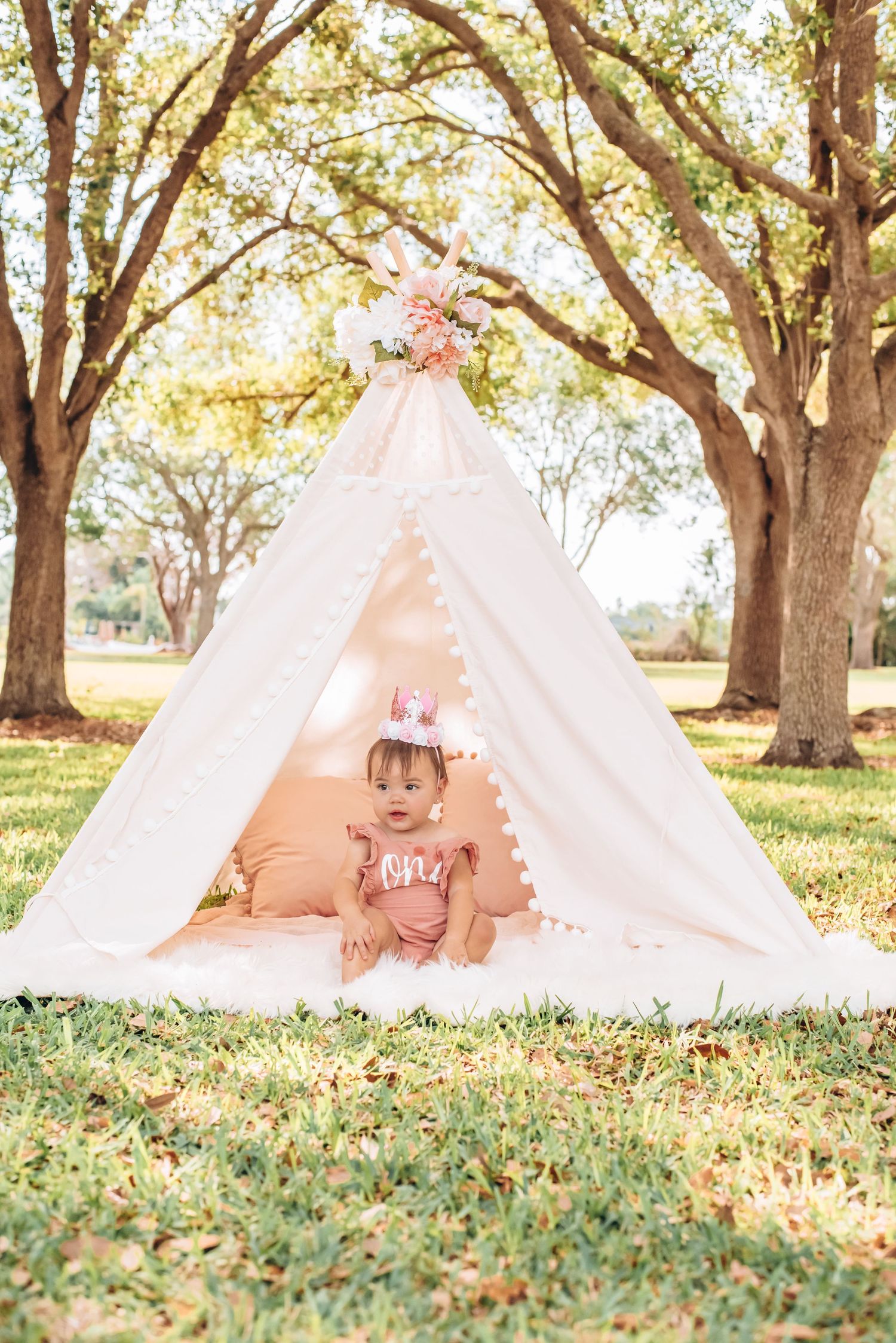 First birthday cake smash with soft pastel decor and joyful expressions