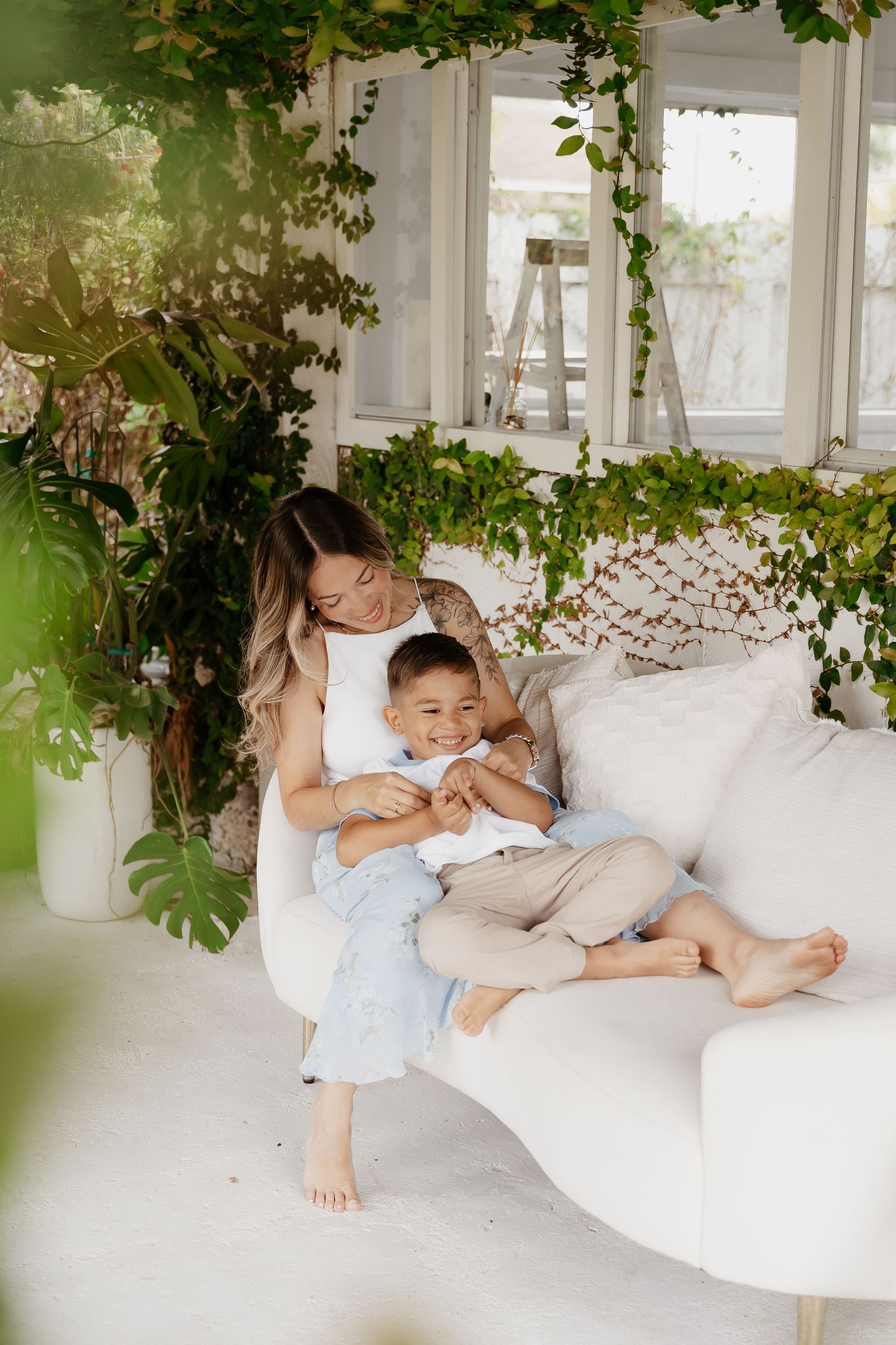 Mother laughing with child close during in-home lifestyle family session in Miami, FL