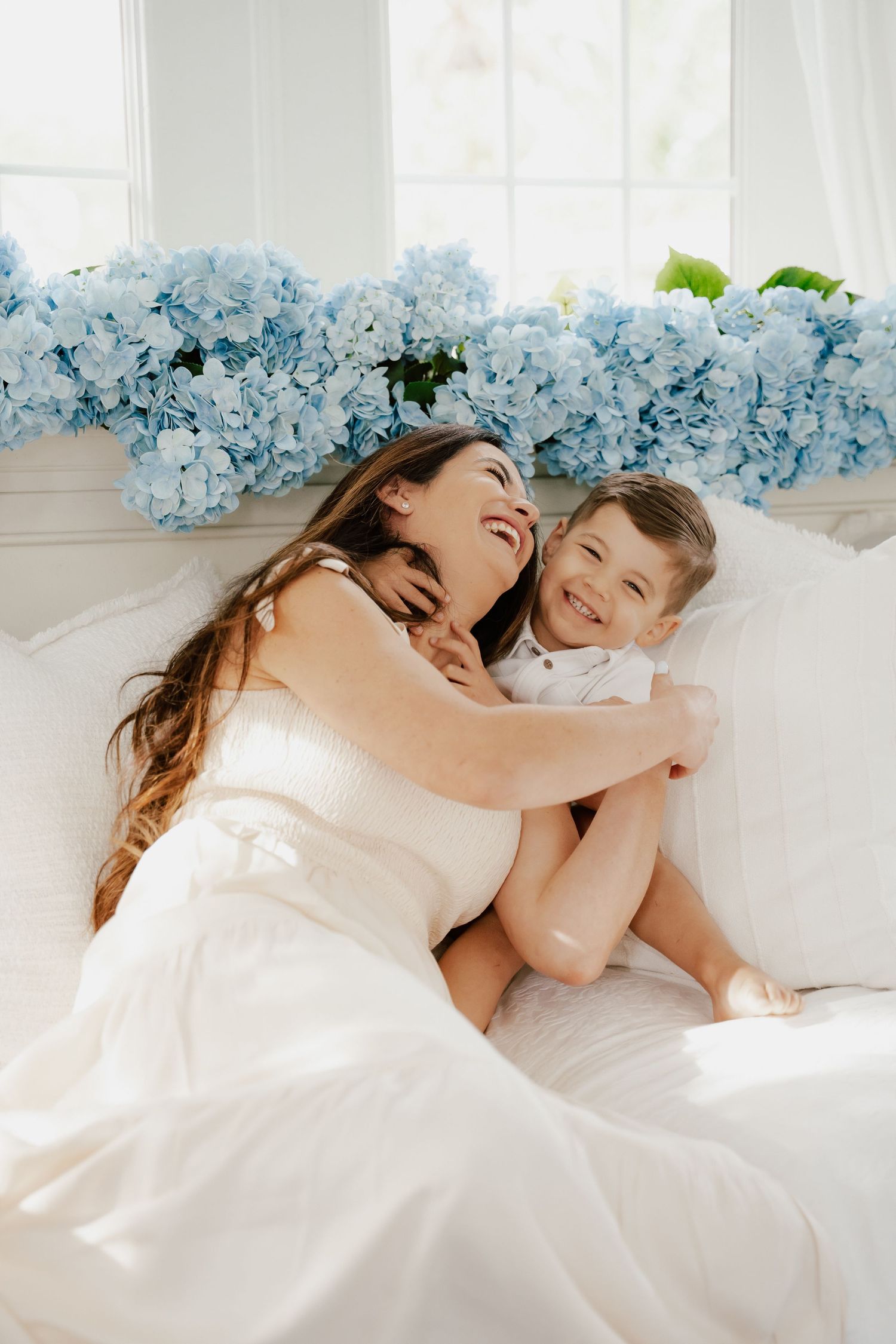 Editorial-style portrait of family in neutral tones during coastal shoot