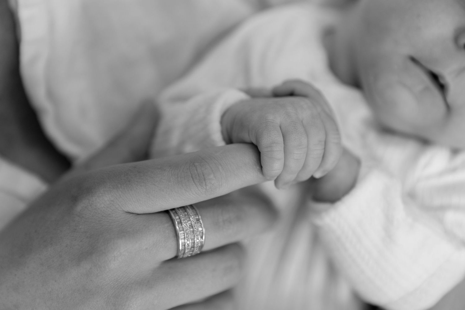 Close-up details of tender moments between parents and baby.