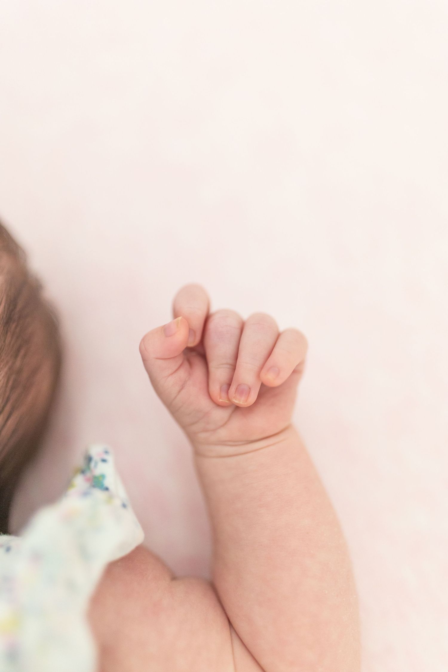 Natural, unposed newborn moments in a cosy home setting.